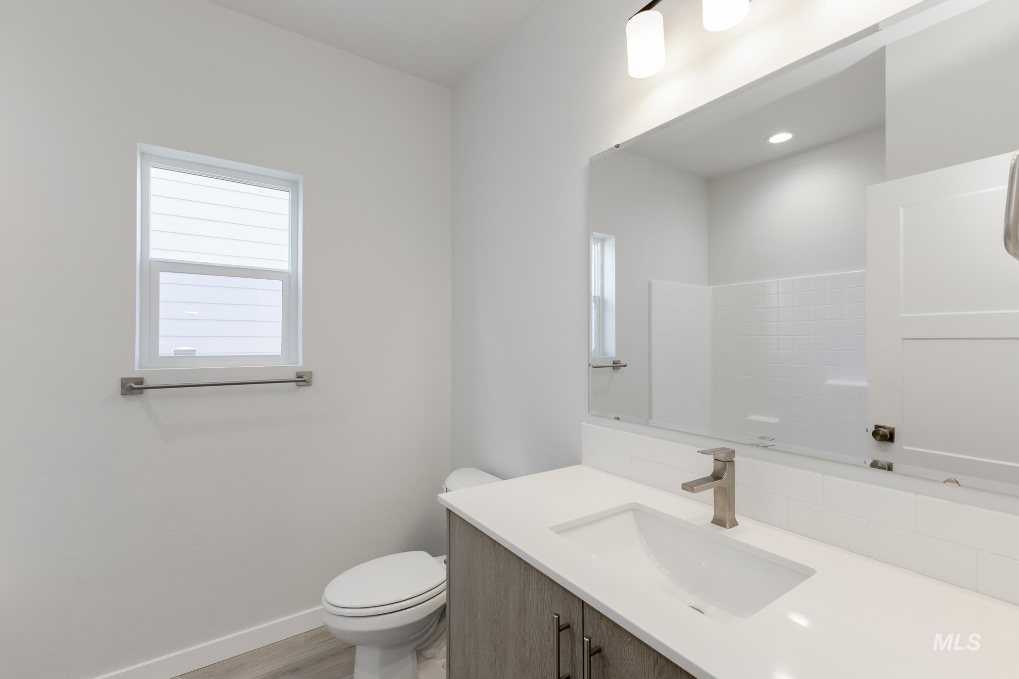 Full bath featuring vanity and light wood finished floors