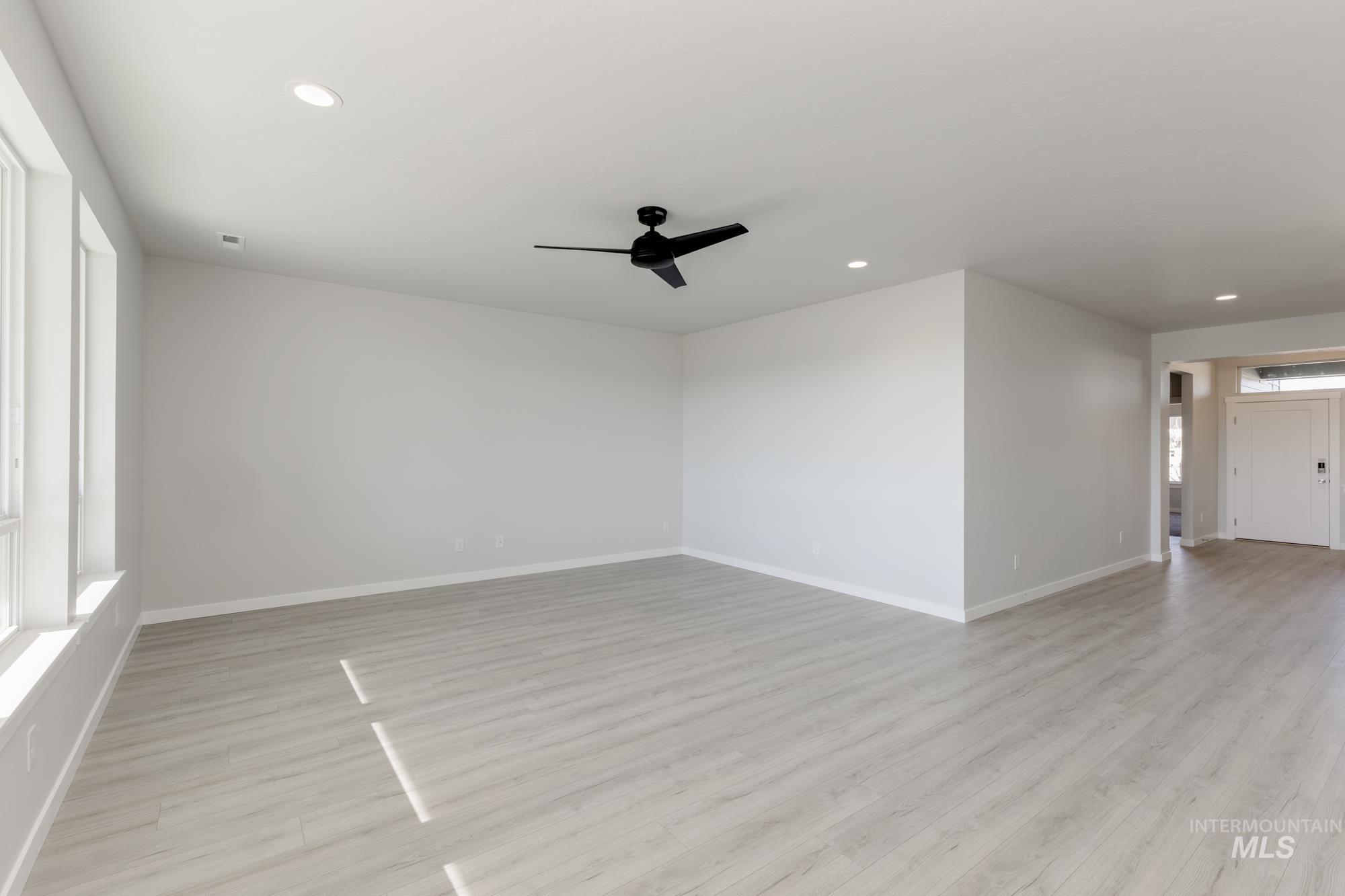 Unfurnished room with light wood-style flooring, ceiling fan, and recessed lighting