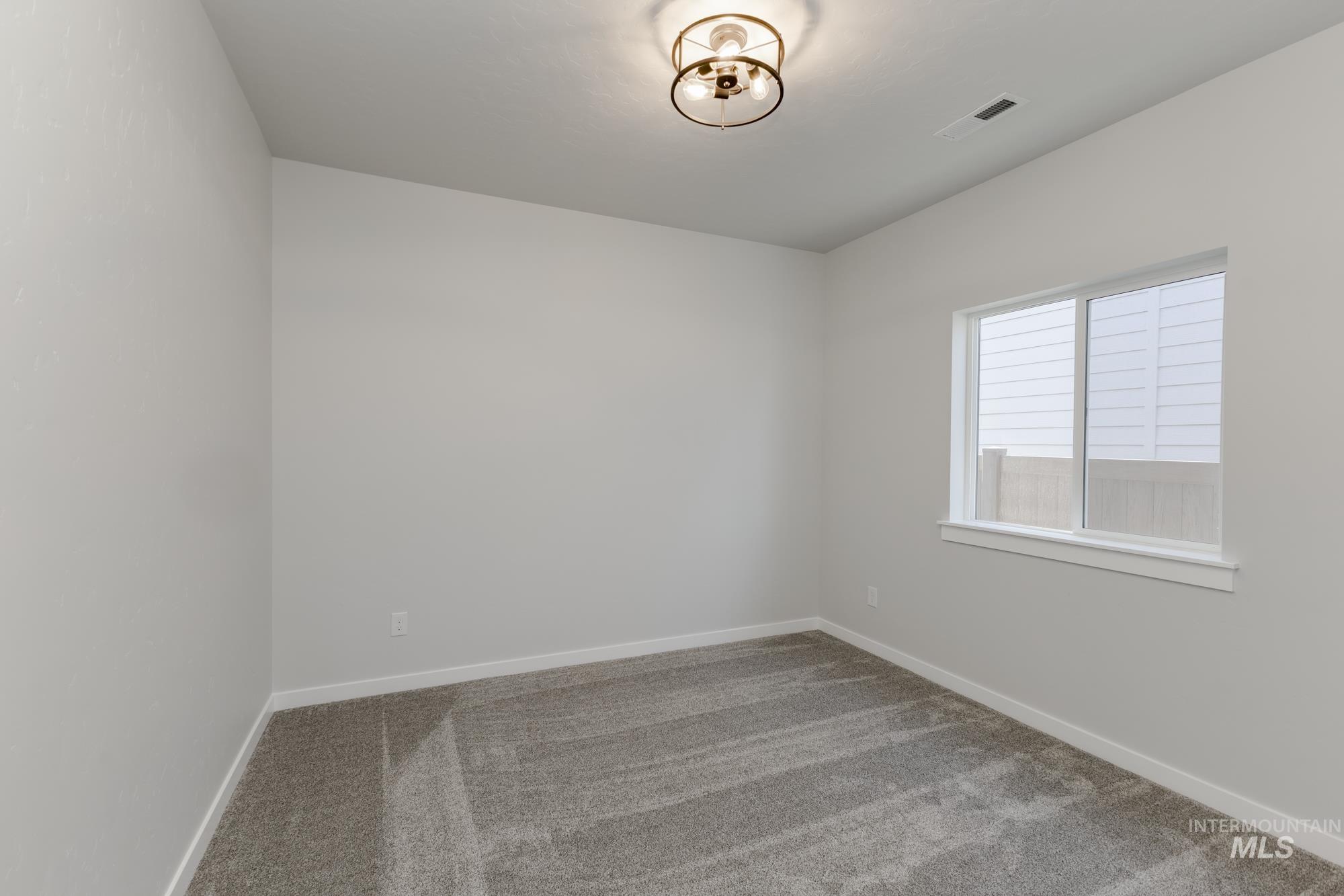 Unfurnished room with carpet floors and baseboards