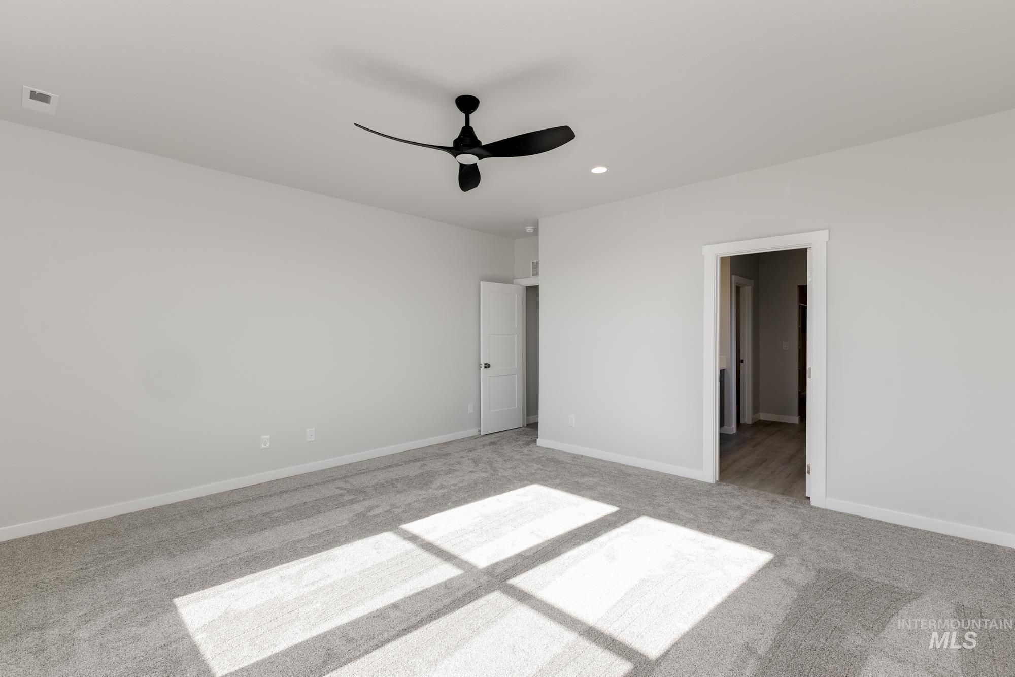 Unfurnished bedroom featuring ceiling fan, light carpet, and recessed lighting