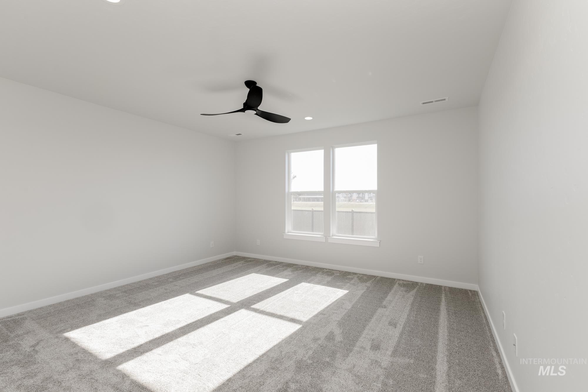 Empty room featuring carpet floors, recessed lighting, and ceiling fan