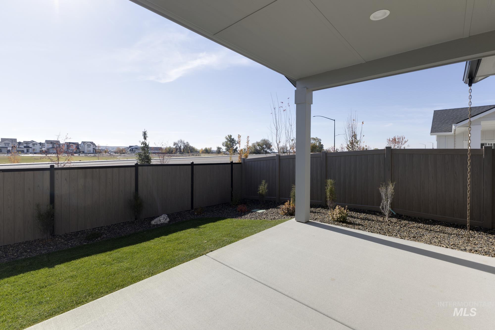 Fenced backyard with a patio area