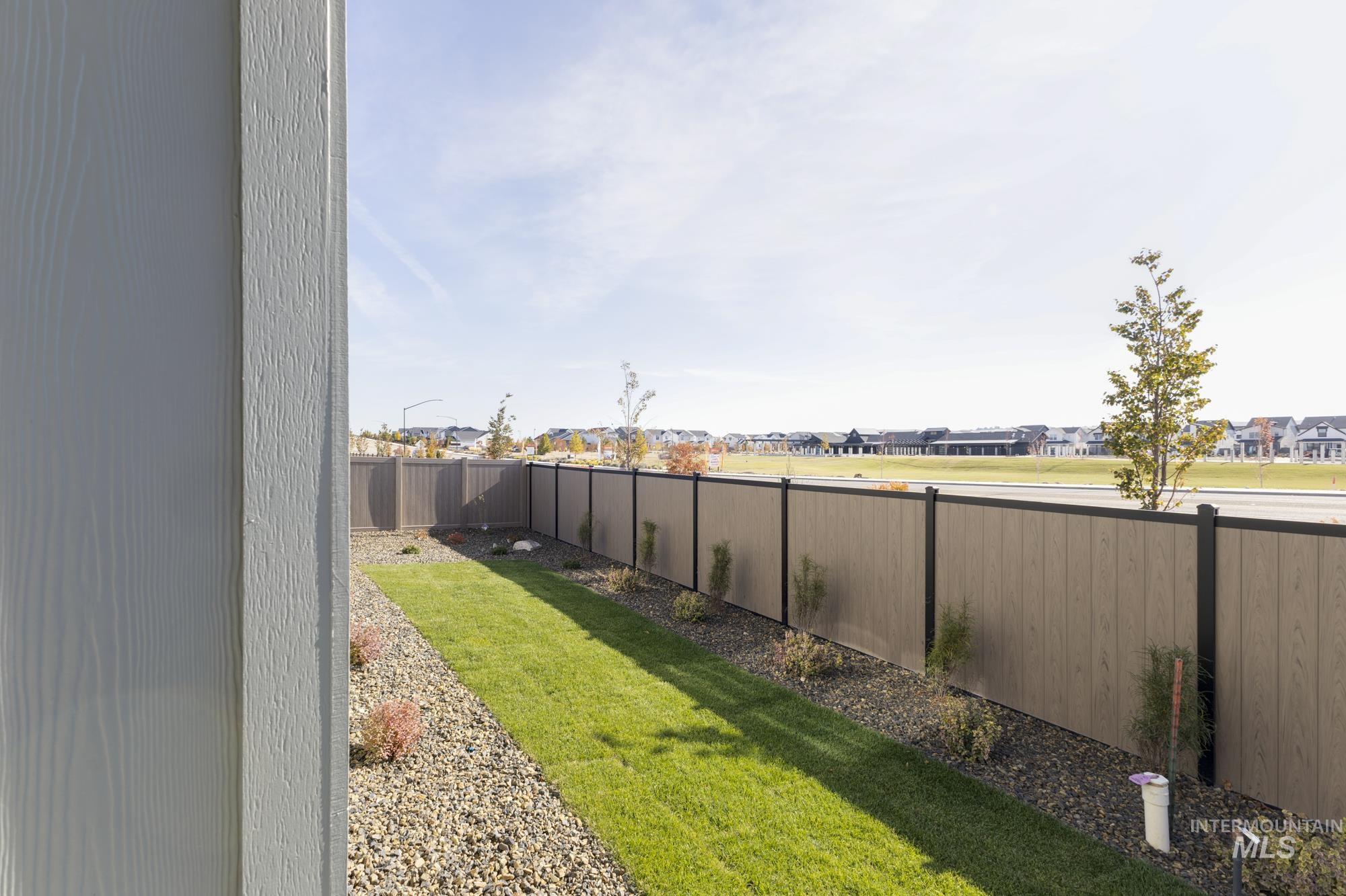 Fenced backyard featuring a residential view