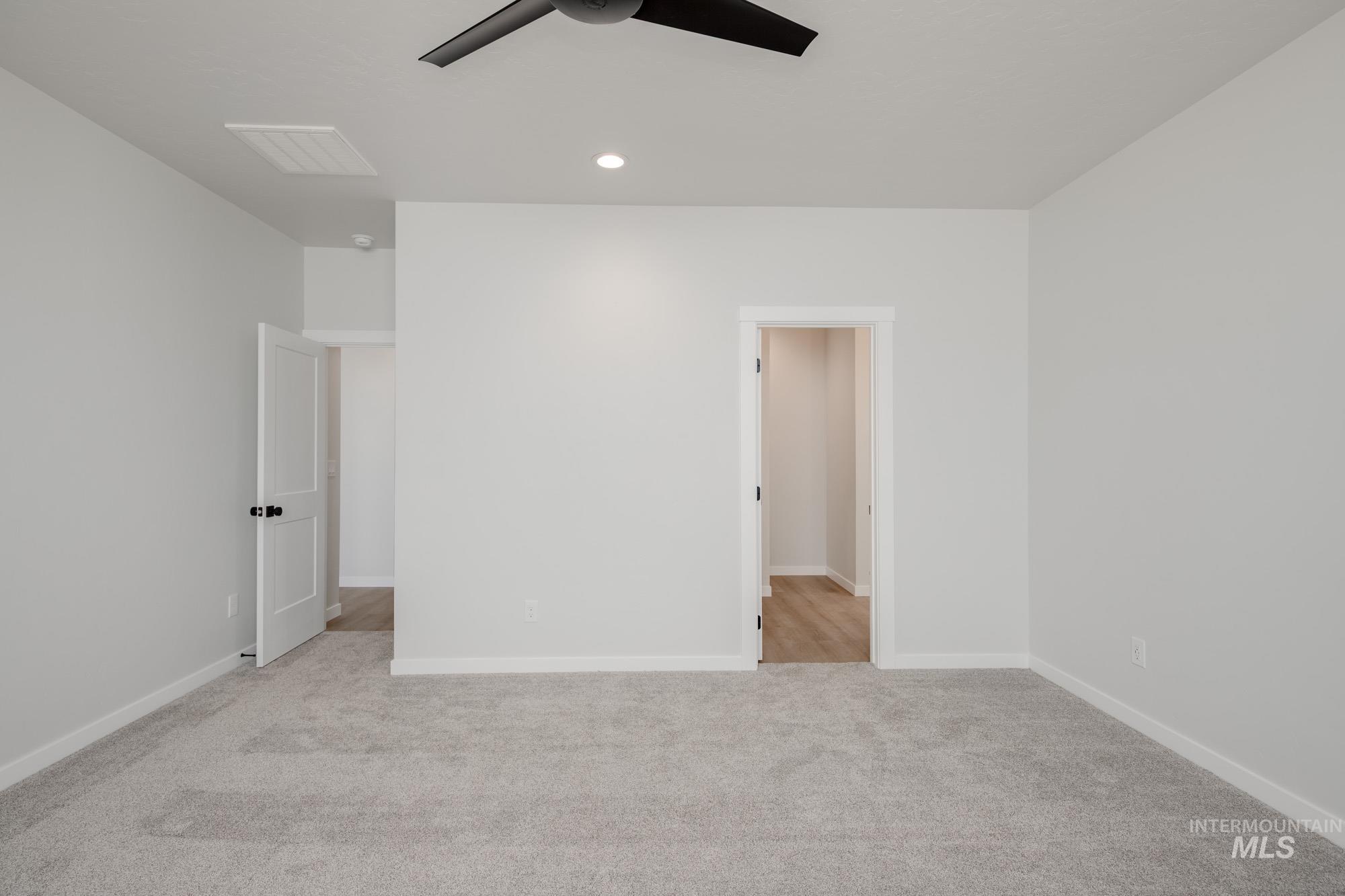 Unfurnished bedroom featuring light colored carpet, recessed lighting, and a ceiling fan