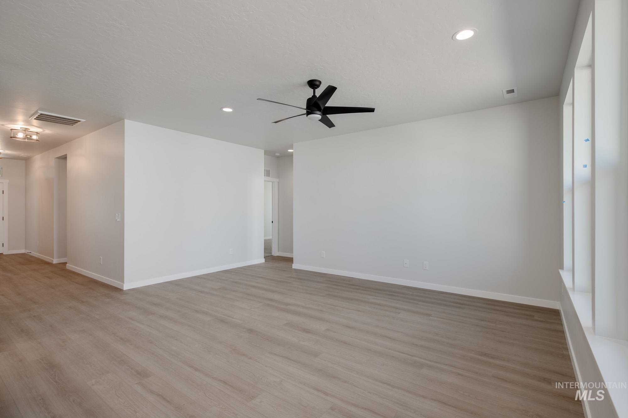 Spare room with light wood-style floors, recessed lighting, and ceiling fan