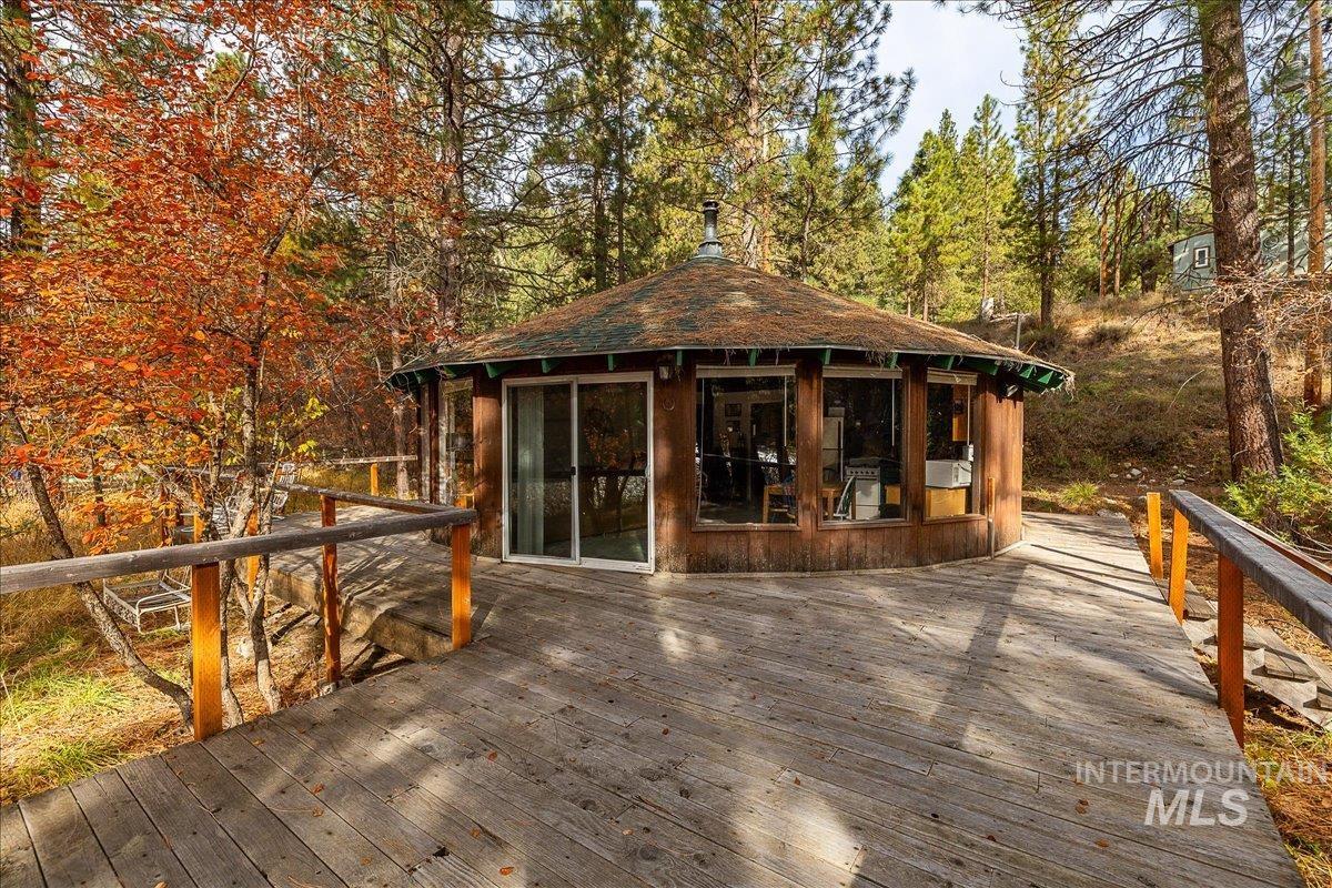 Wooden deck with a sunroom and an outdoor structure