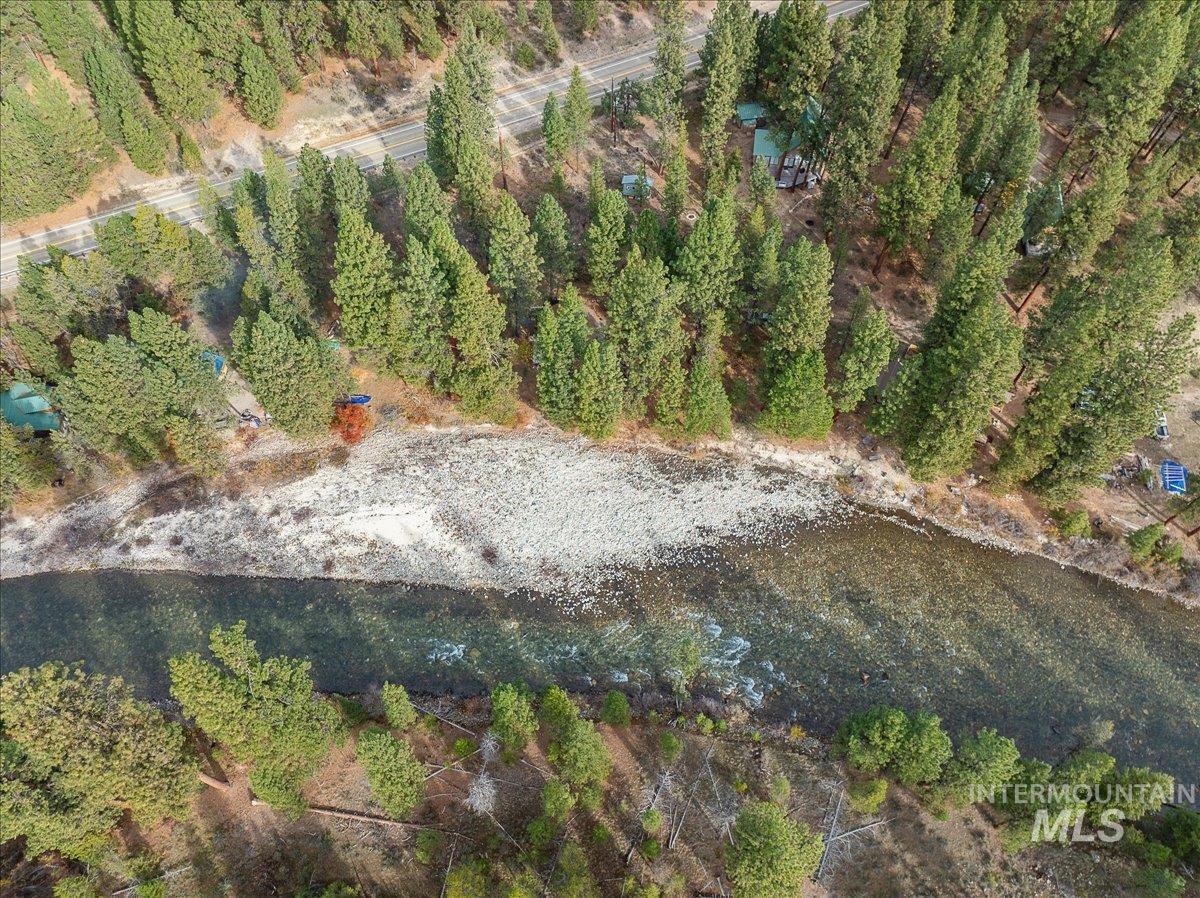Aerial view of property and surrounding area with a nearby body of water
