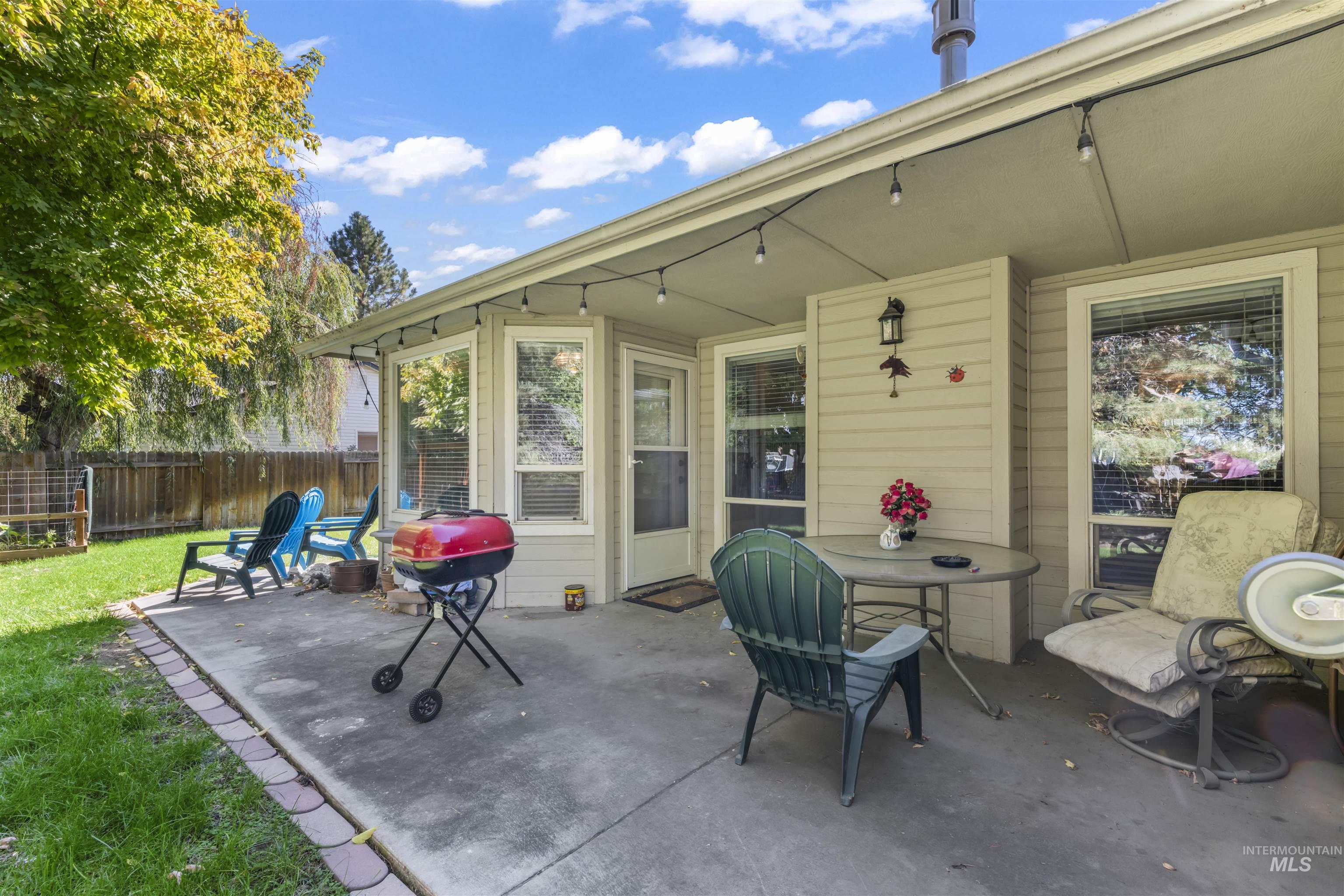View of patio with a grill