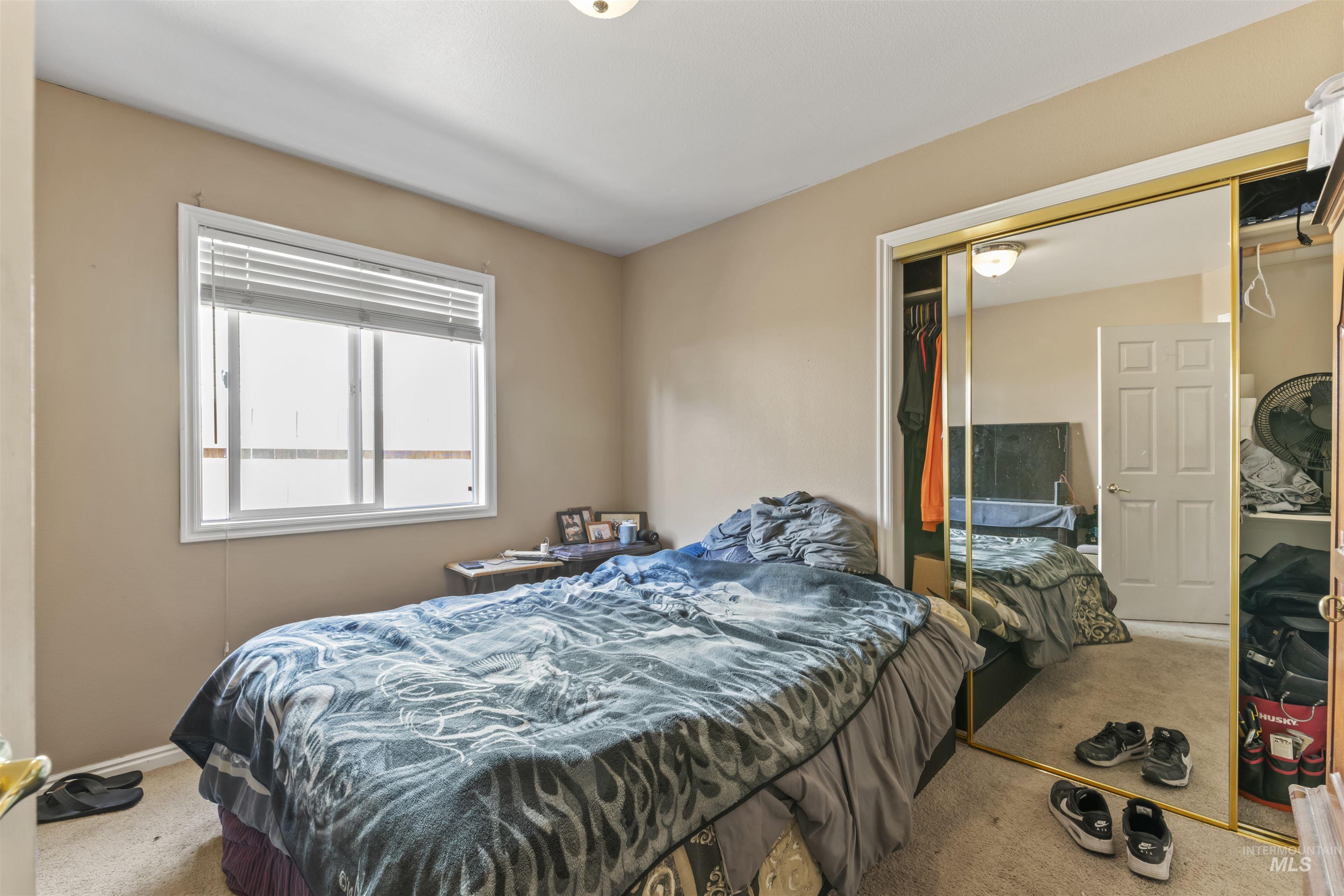 Bedroom featuring carpet floors and a closet