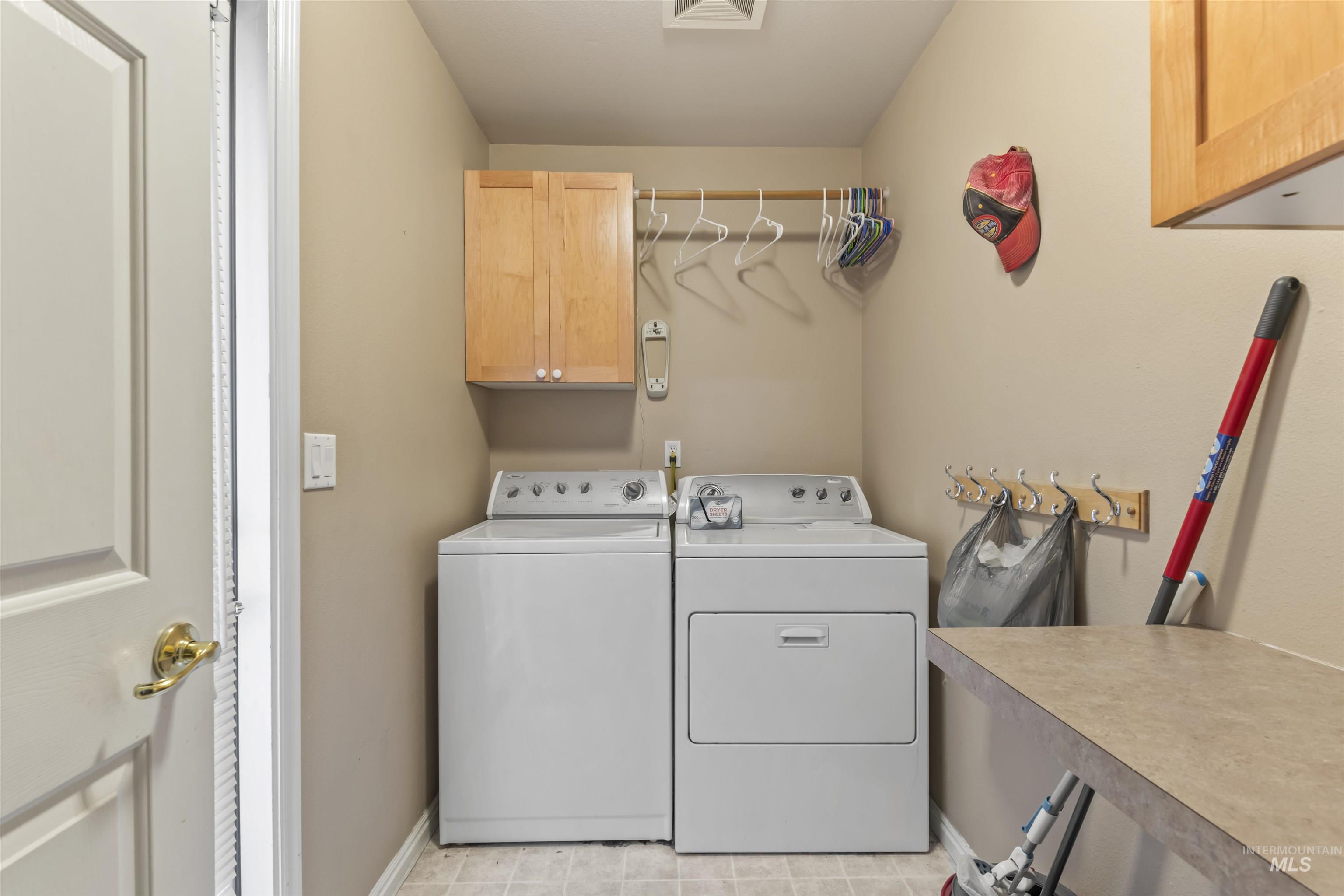 Laundry room with cabinet space and washing machine and dryer