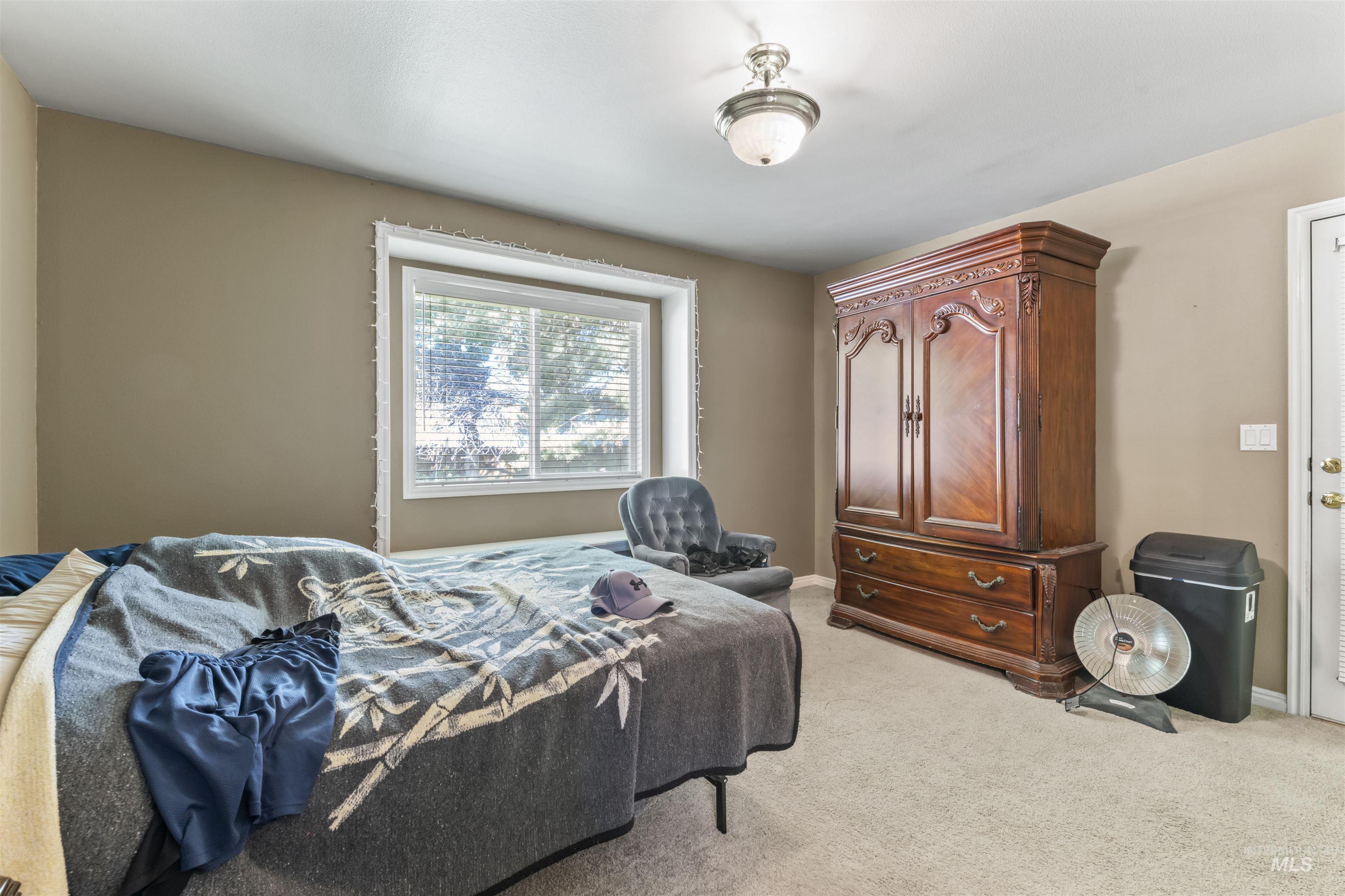 Bedroom featuring light colored carpet and baseboards