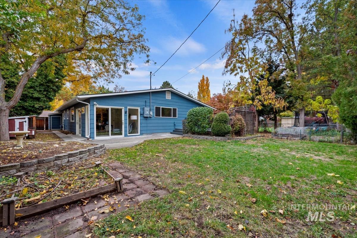 Back of property with a garden and a patio area