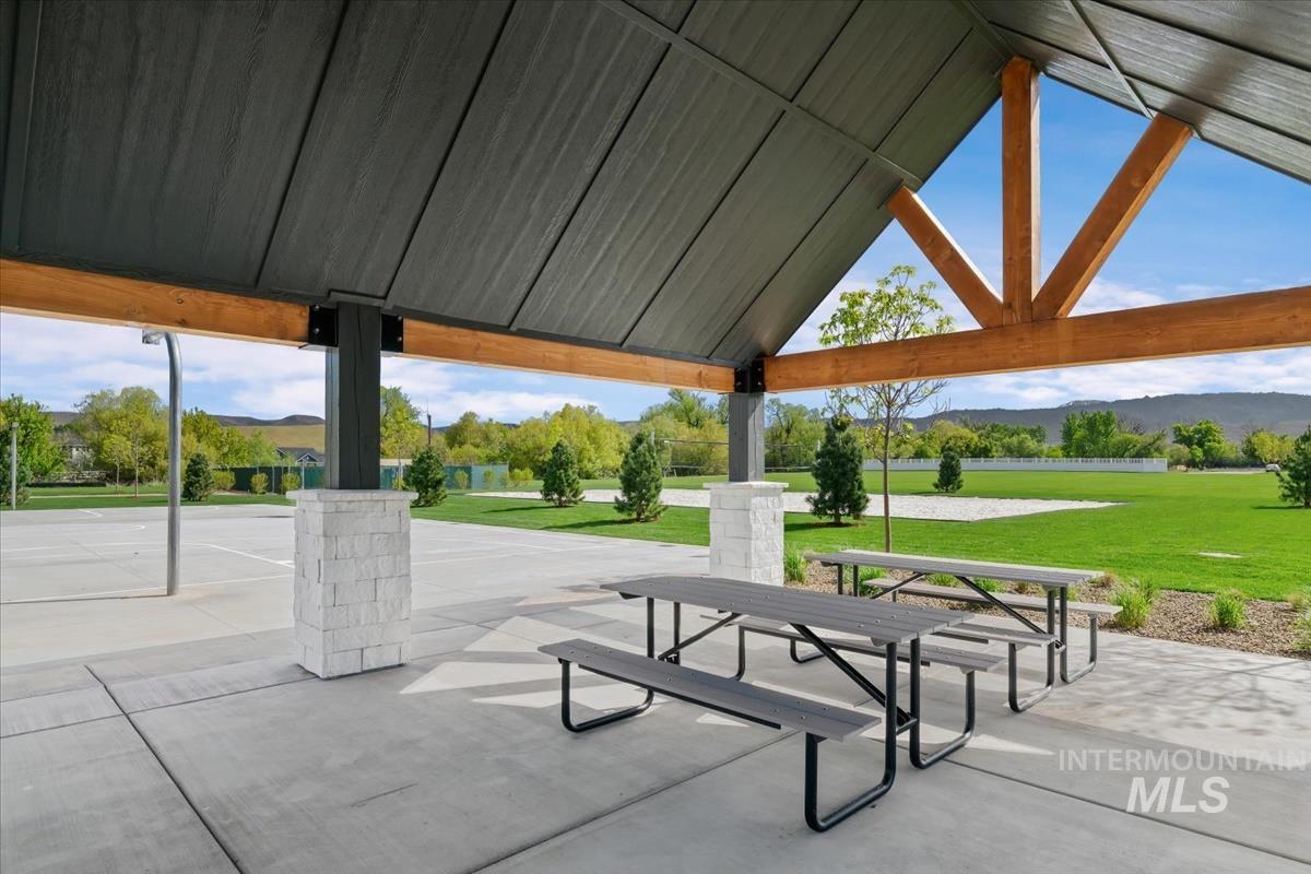 View of community featuring a yard, a patio, and a mountain view