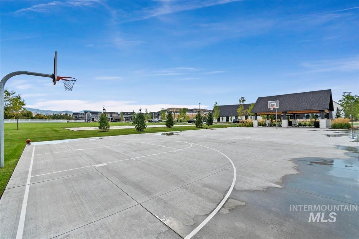 View of basketball court featuring community basketball court and a yard