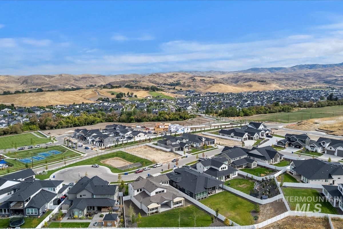 Aerial view of property's location featuring nearby suburban area and a mountain backdrop
