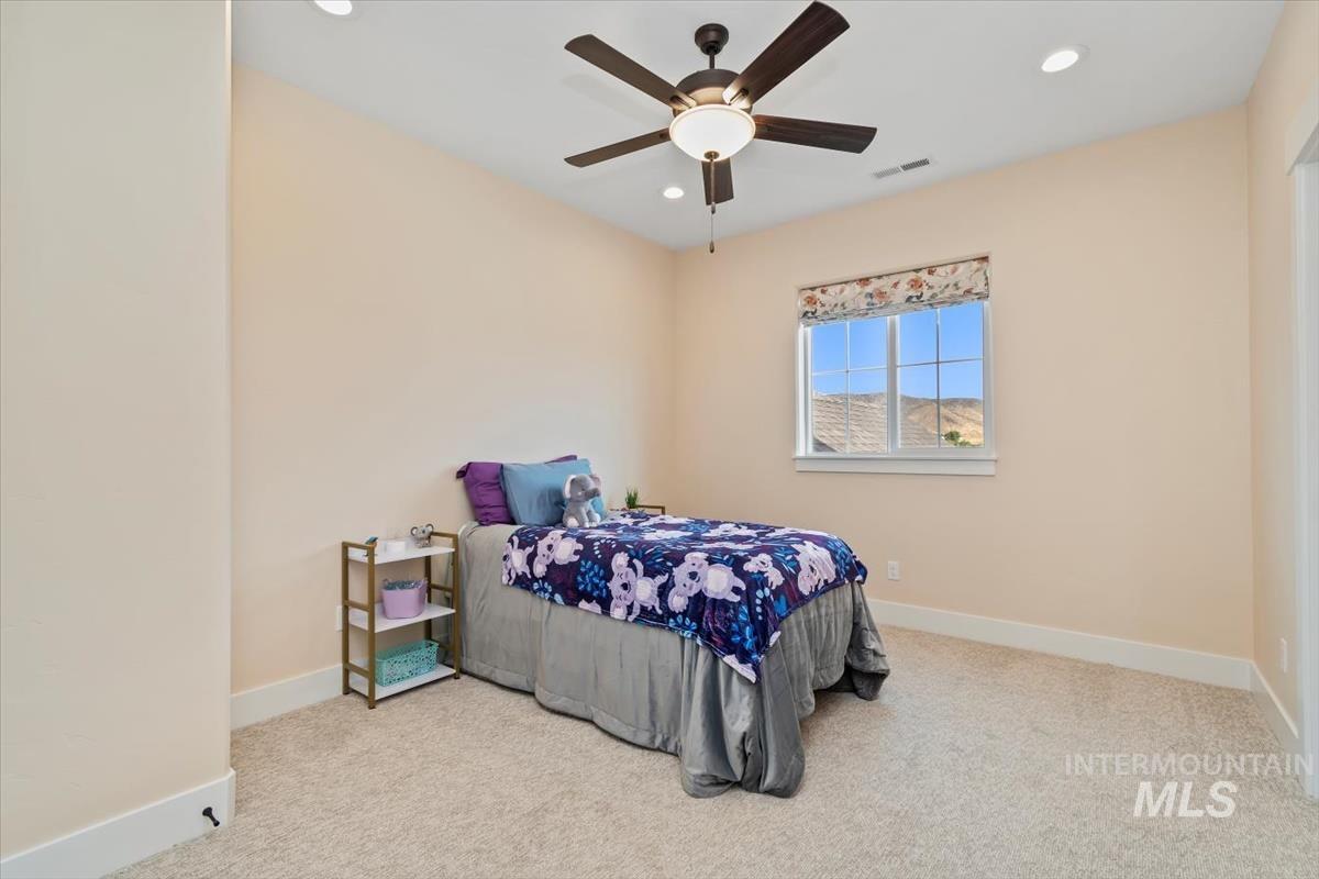 Bedroom featuring light carpet, recessed lighting, and ceiling fan
