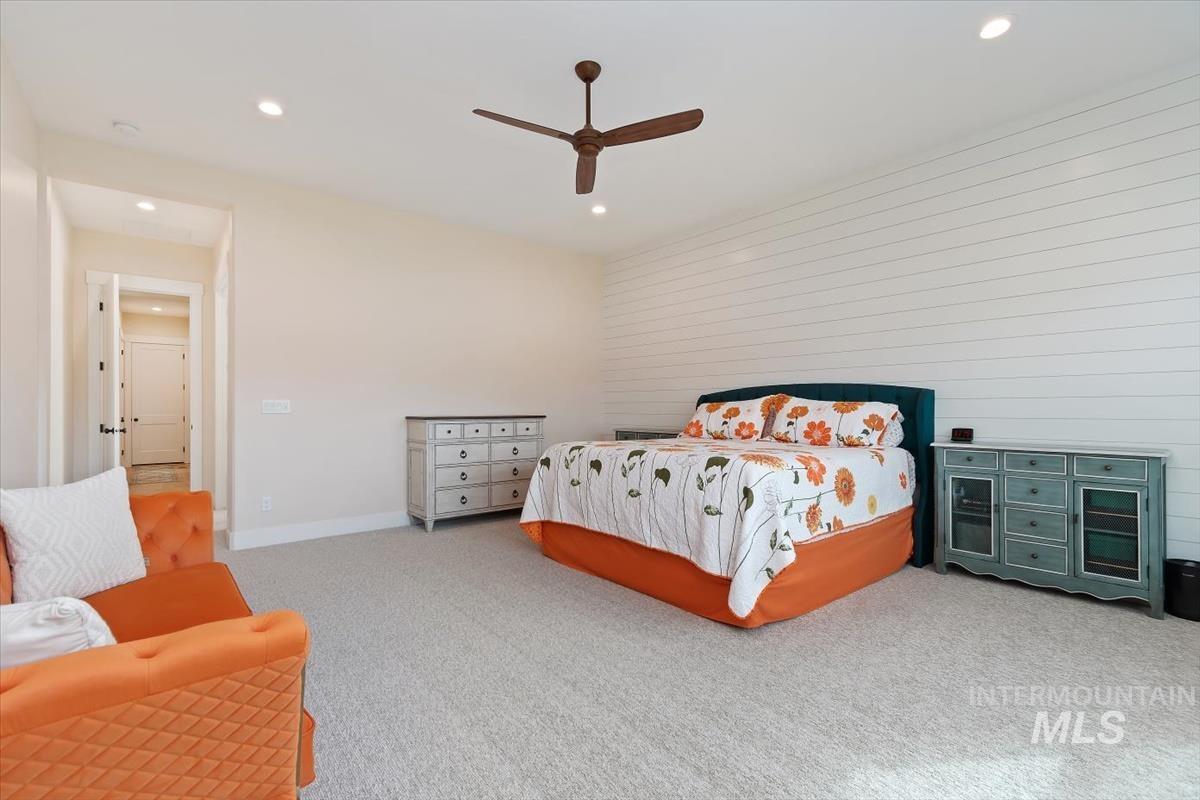 Carpeted bedroom with recessed lighting and ceiling fan
