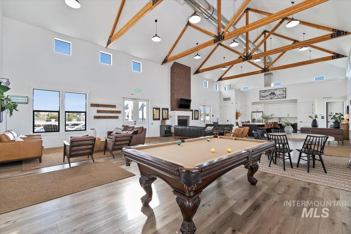 Playroom featuring high vaulted ceiling, pool table, wood finished floors, and beam ceiling