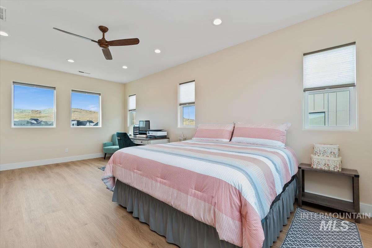 Bedroom with recessed lighting, light wood-style floors, and a ceiling fan