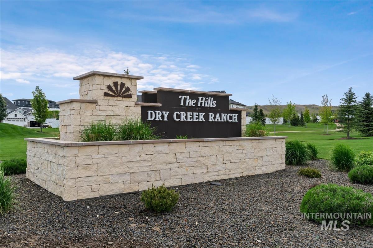 Community / neighborhood sign with a yard