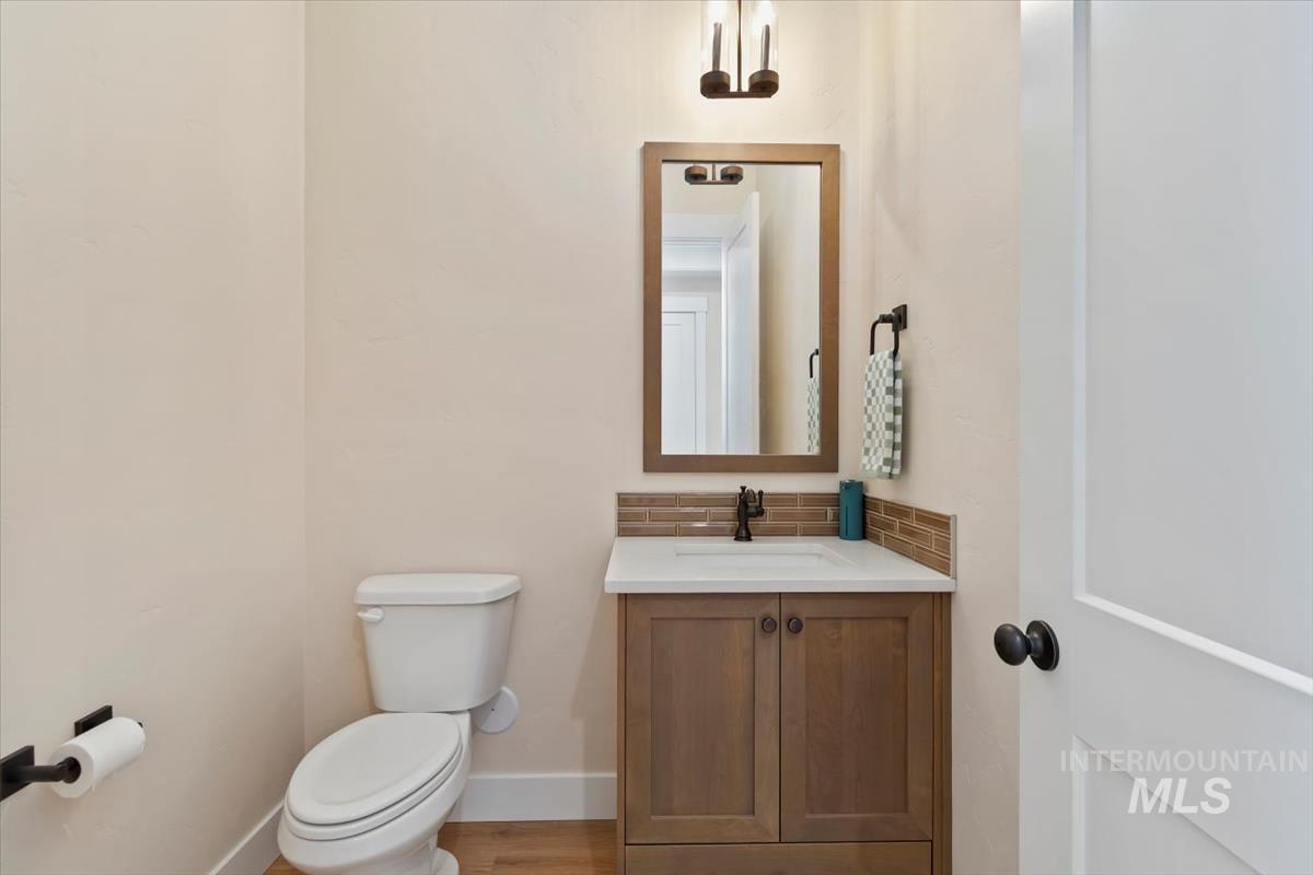 Bathroom with vanity and tasteful backsplash