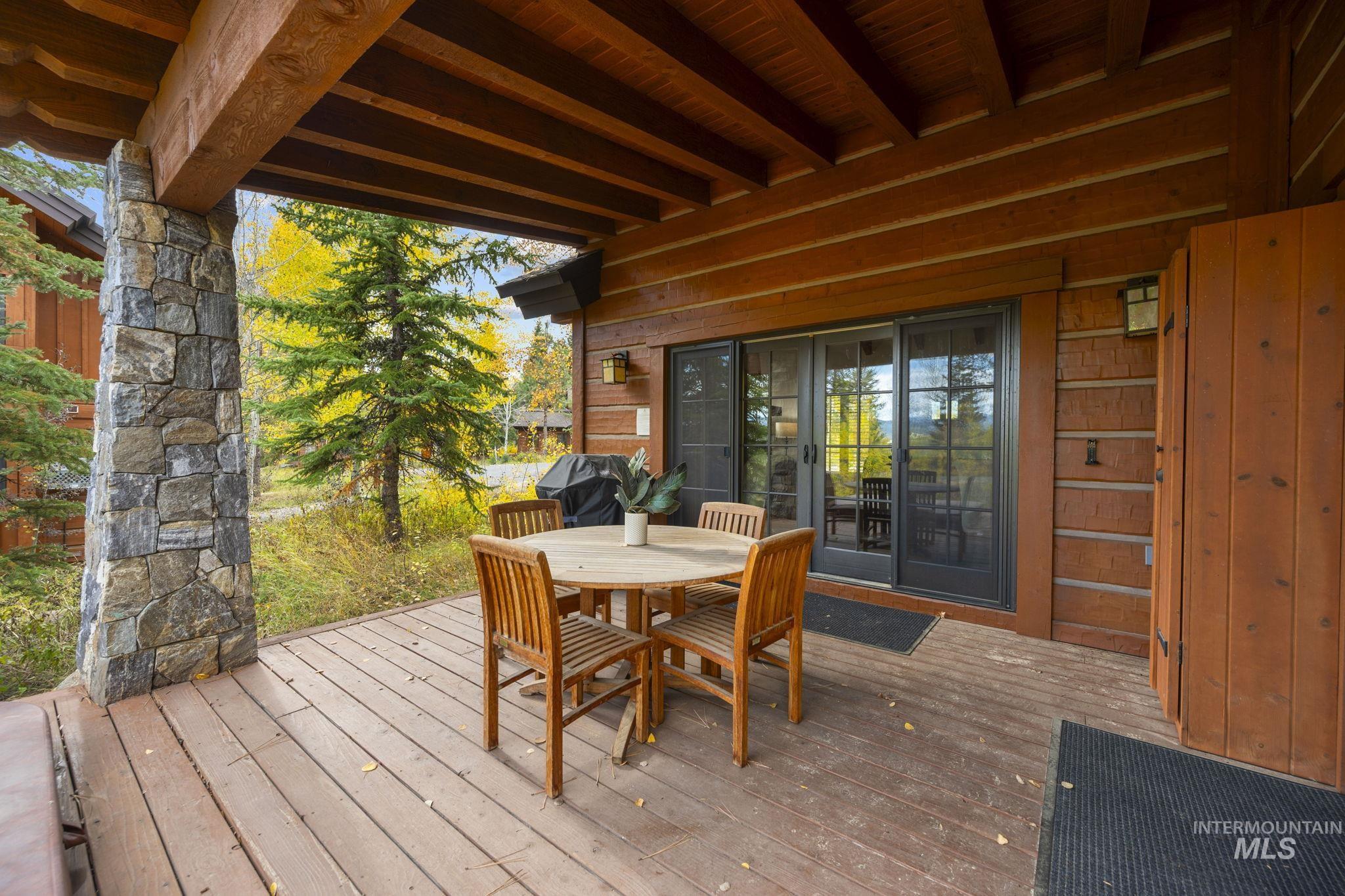 Wooden terrace with outdoor dining area and grilling area