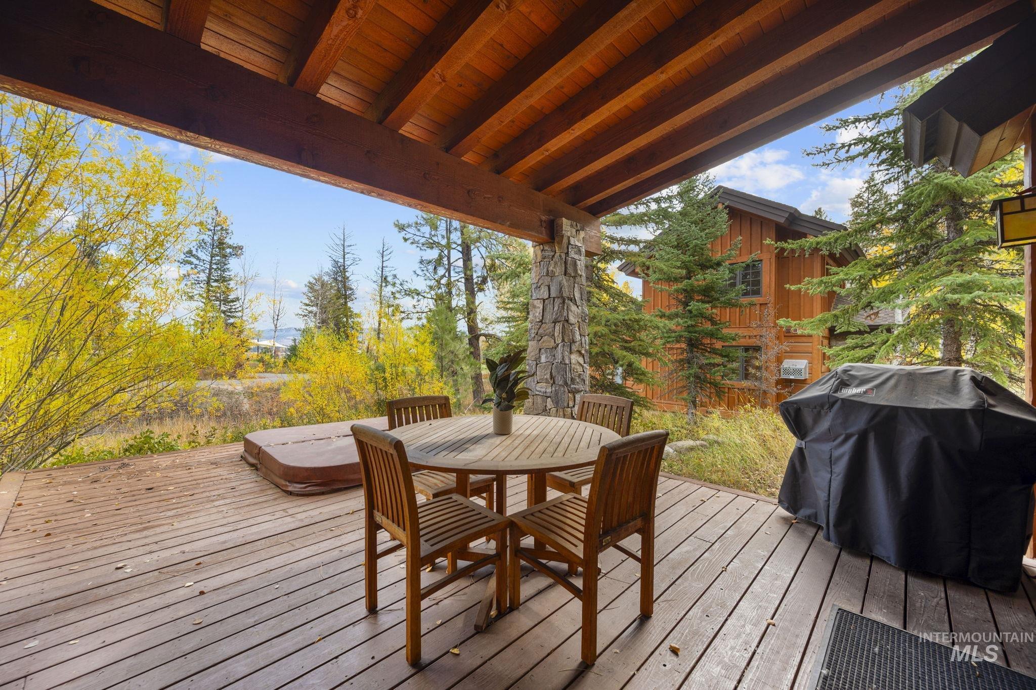 Deck with outdoor dining area and a grill
