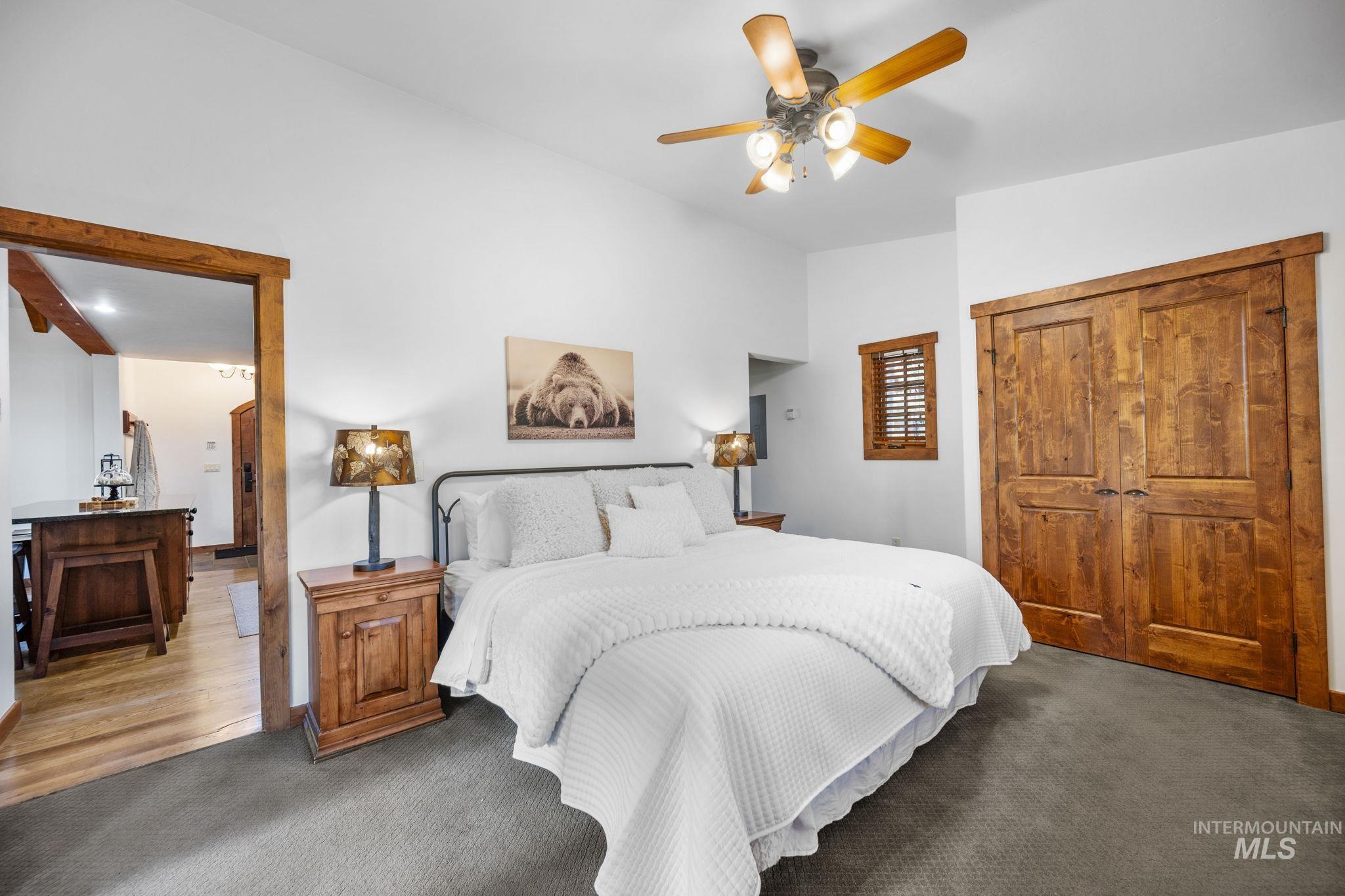 Carpeted bedroom featuring a closet and ceiling fan
