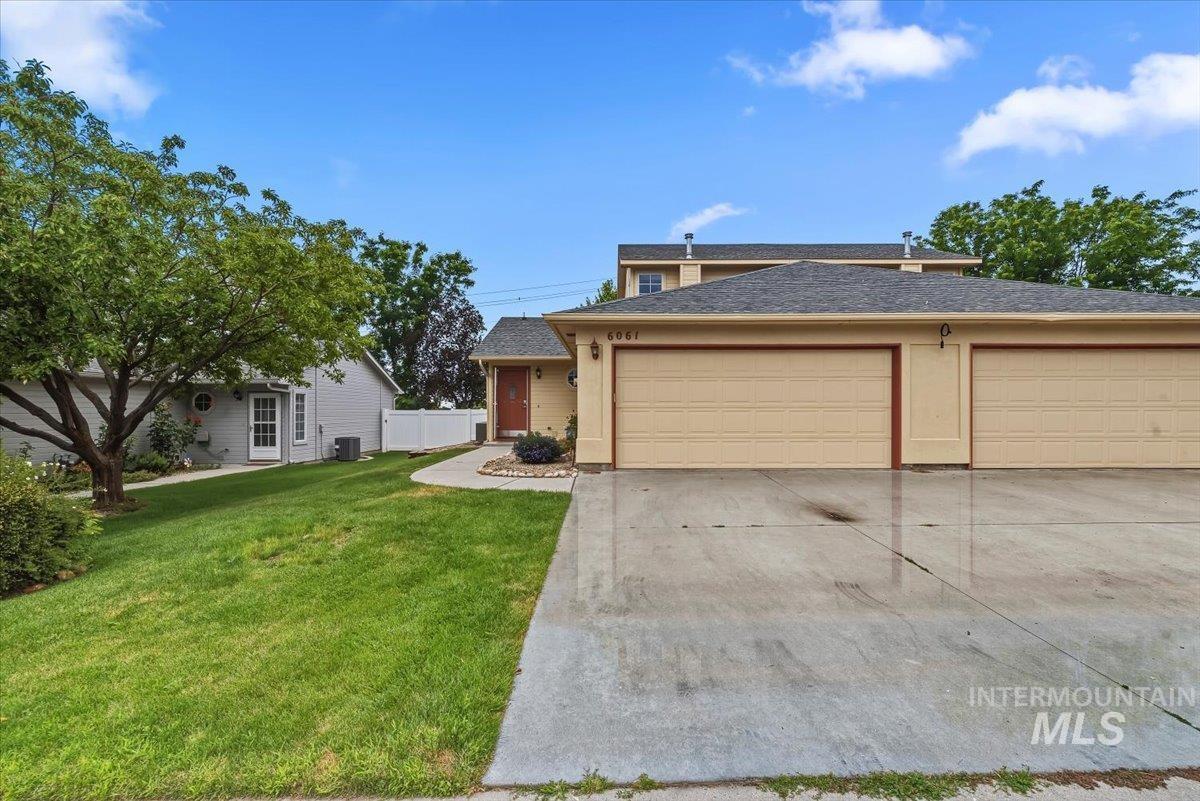 Multi-car garage with concrete driveway