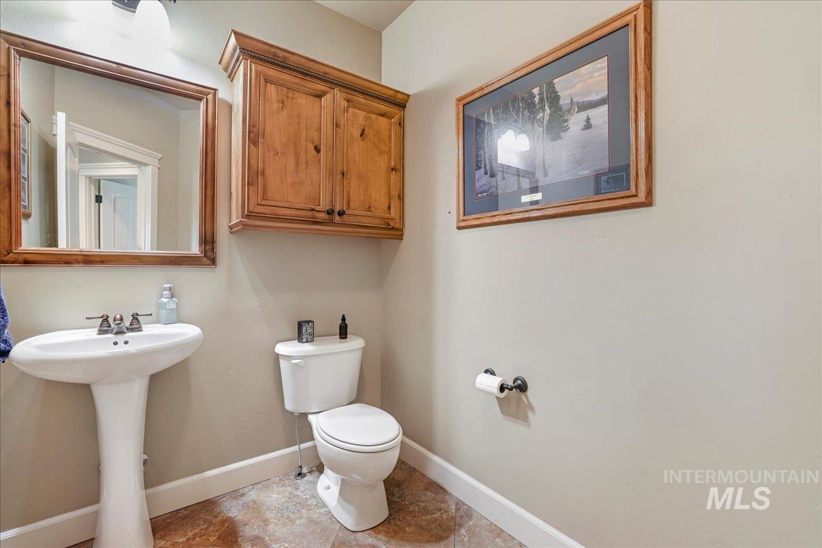 Half bath with toilet and baseboards