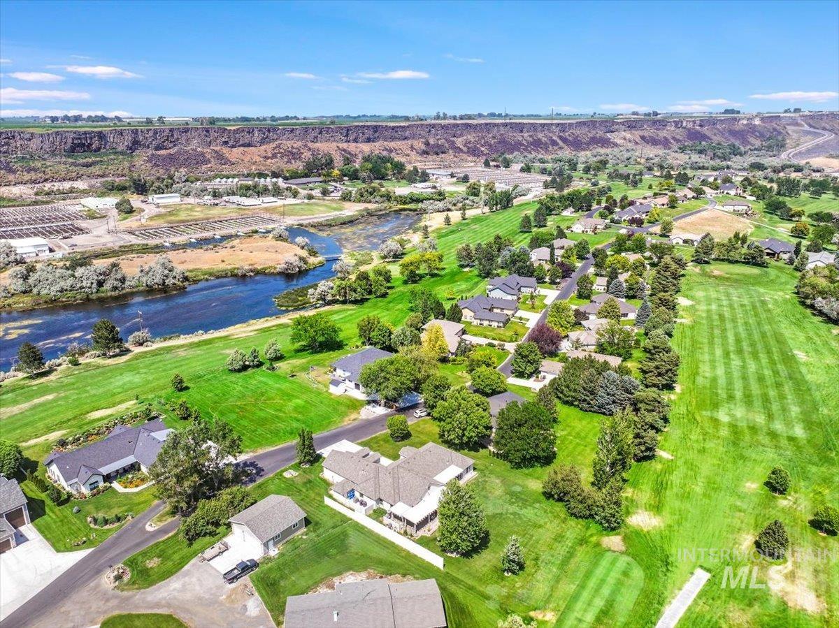 View of property location featuring a large body of water and nearby suburban area