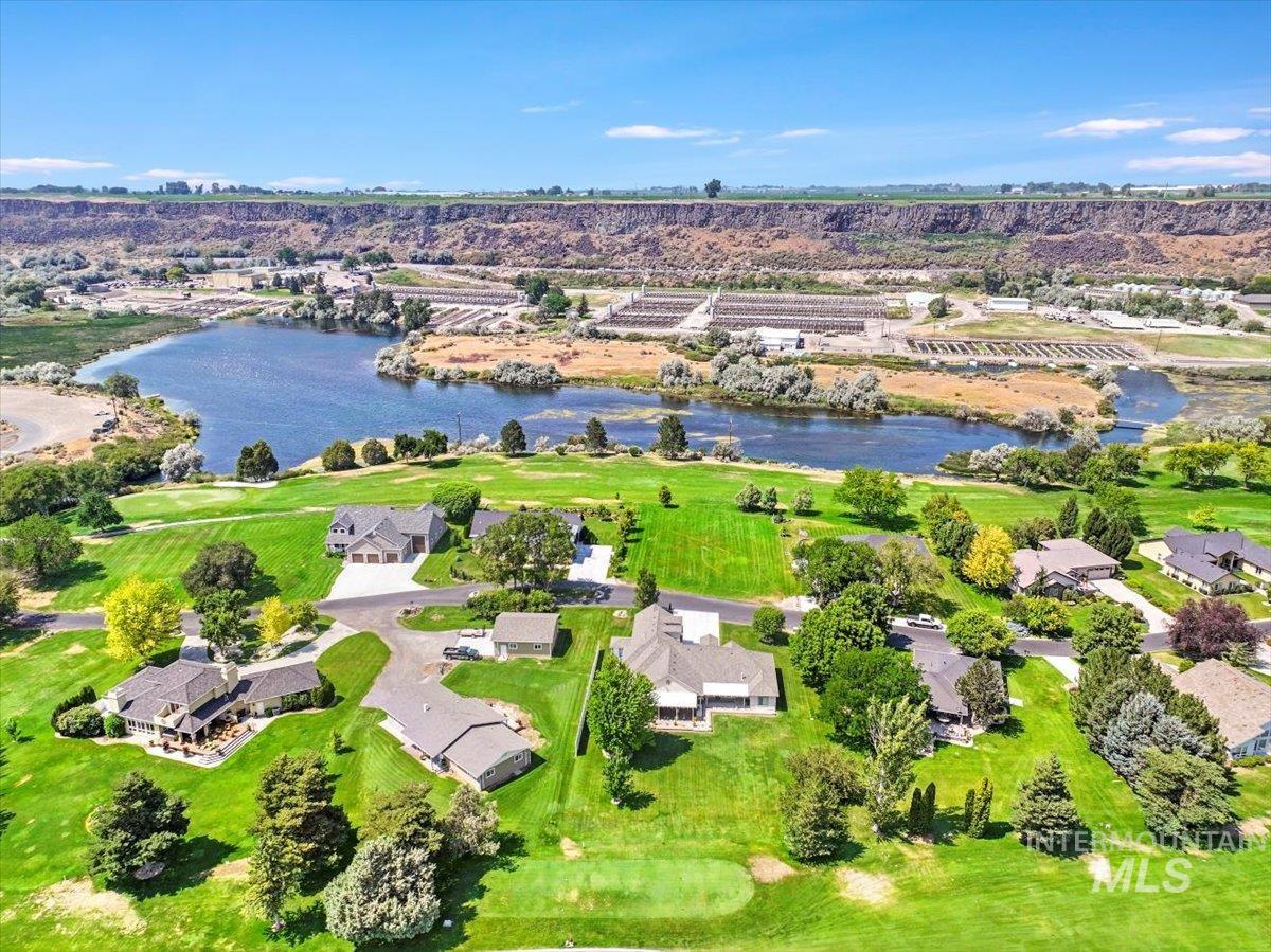 Aerial perspective of suburban area featuring a large body of water