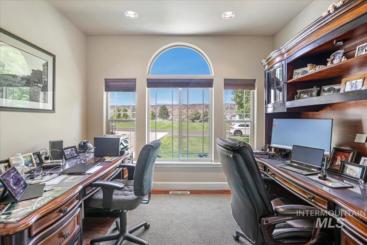 Home office with carpet, healthy amount of natural light, and recessed lighting