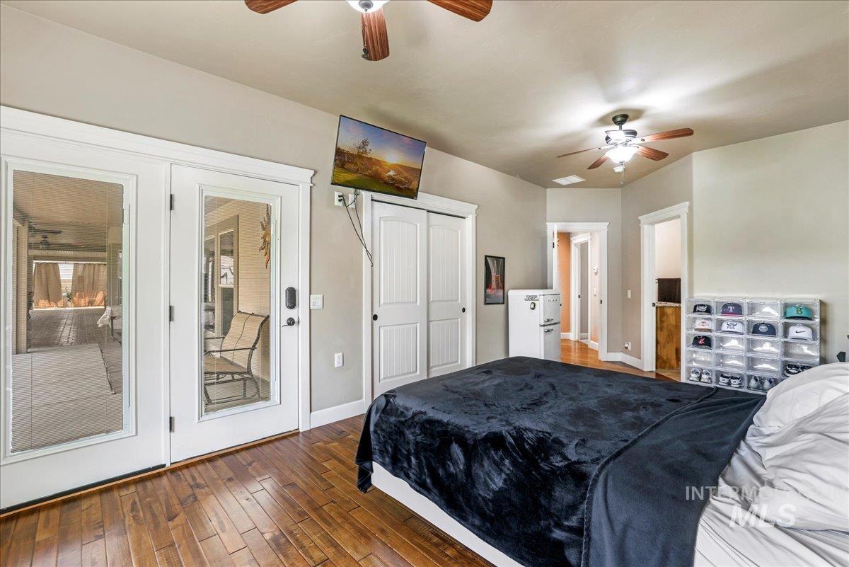 Bedroom with wood-type flooring and ceiling fan