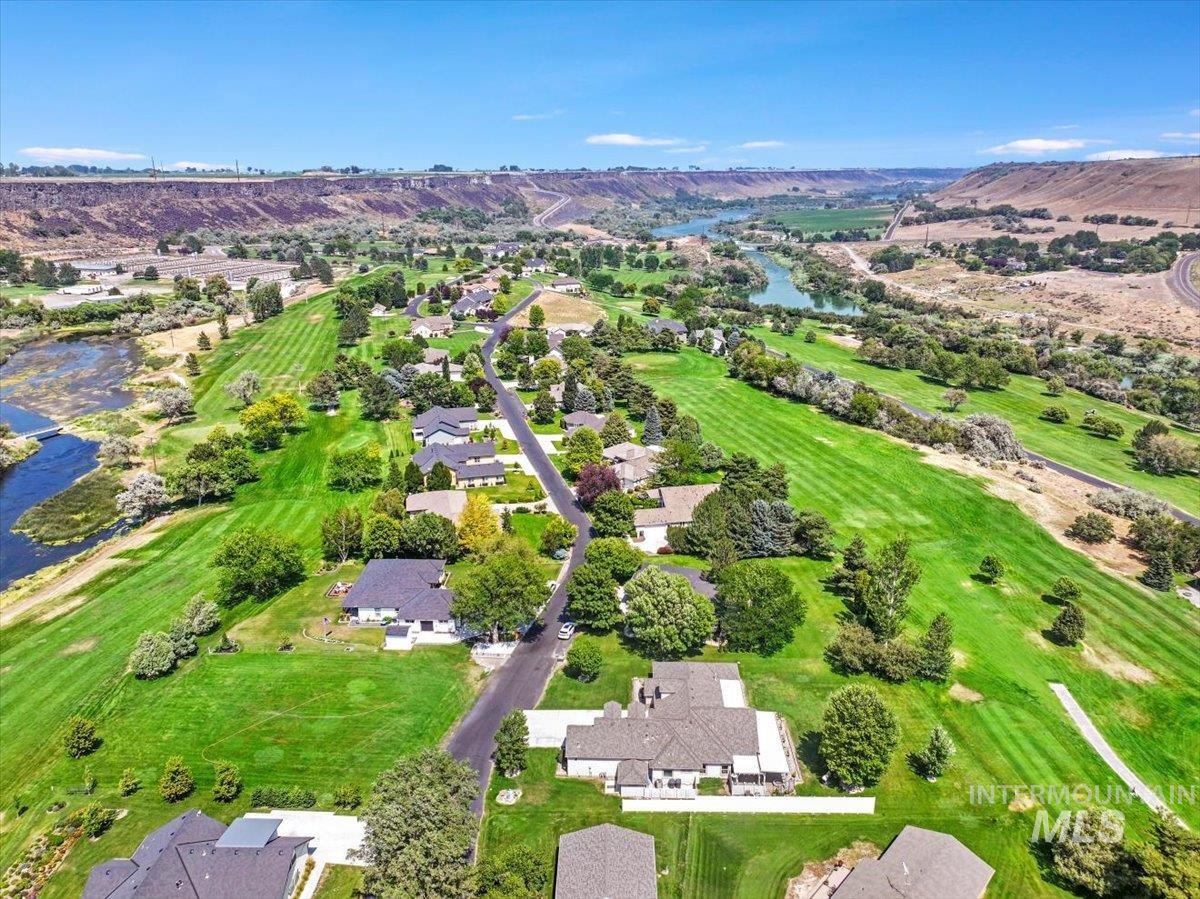 Aerial overview of property's location with a water and mountain view and nearby suburban area