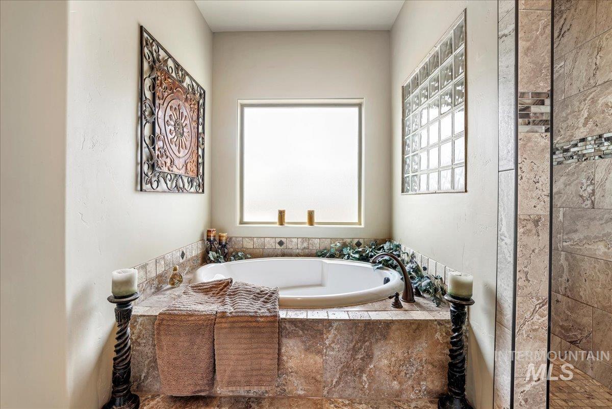 Full bathroom with a garden tub and a tile shower