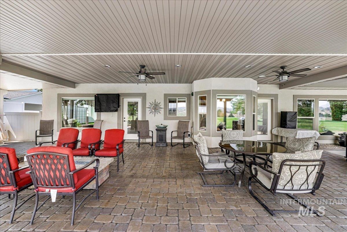 View of patio / terrace featuring a ceiling fan, outdoor dining space, and outdoor lounge area