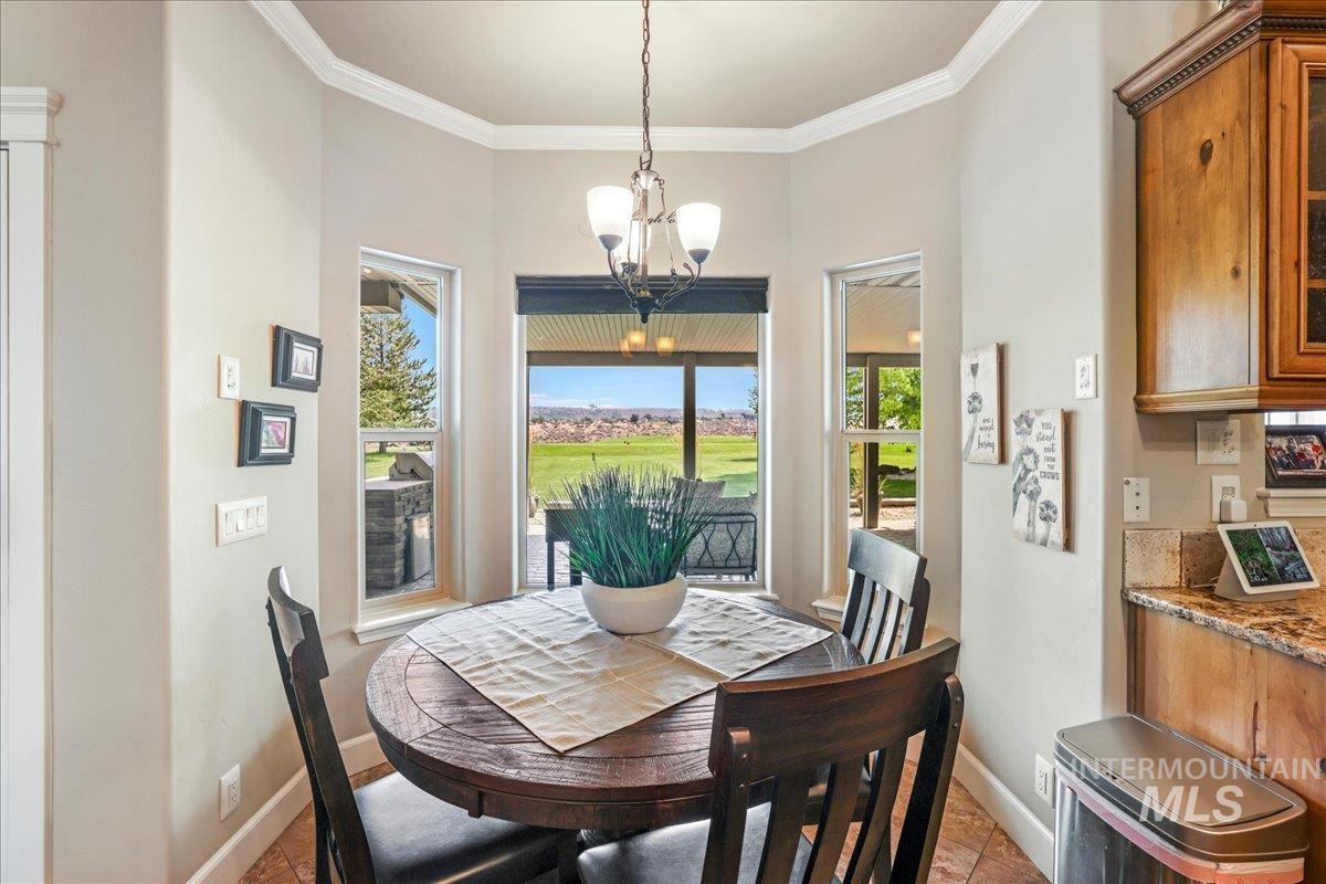 Dining area featuring a chandelier and ornamental molding
