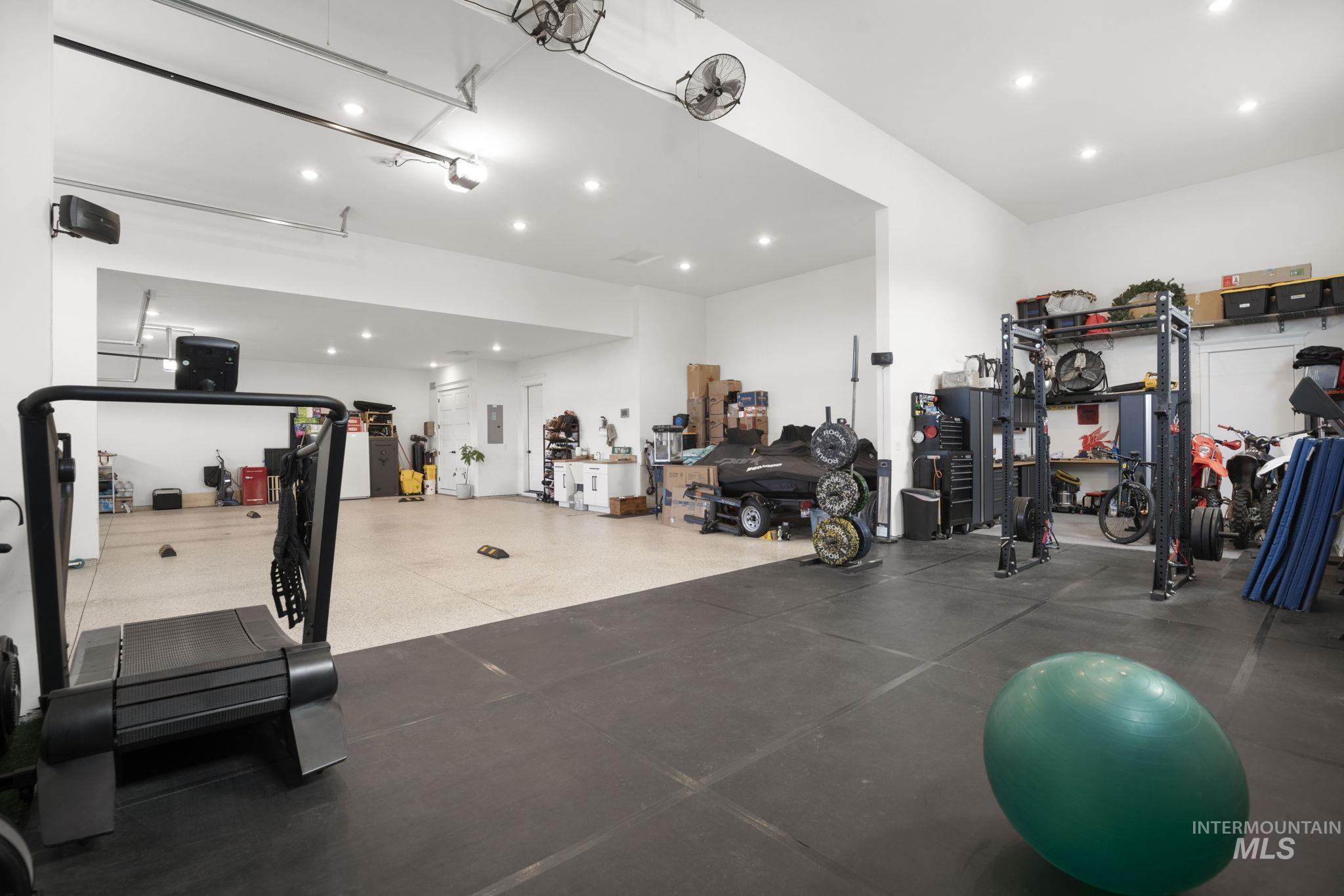 Gym featuring a garage and recessed lighting