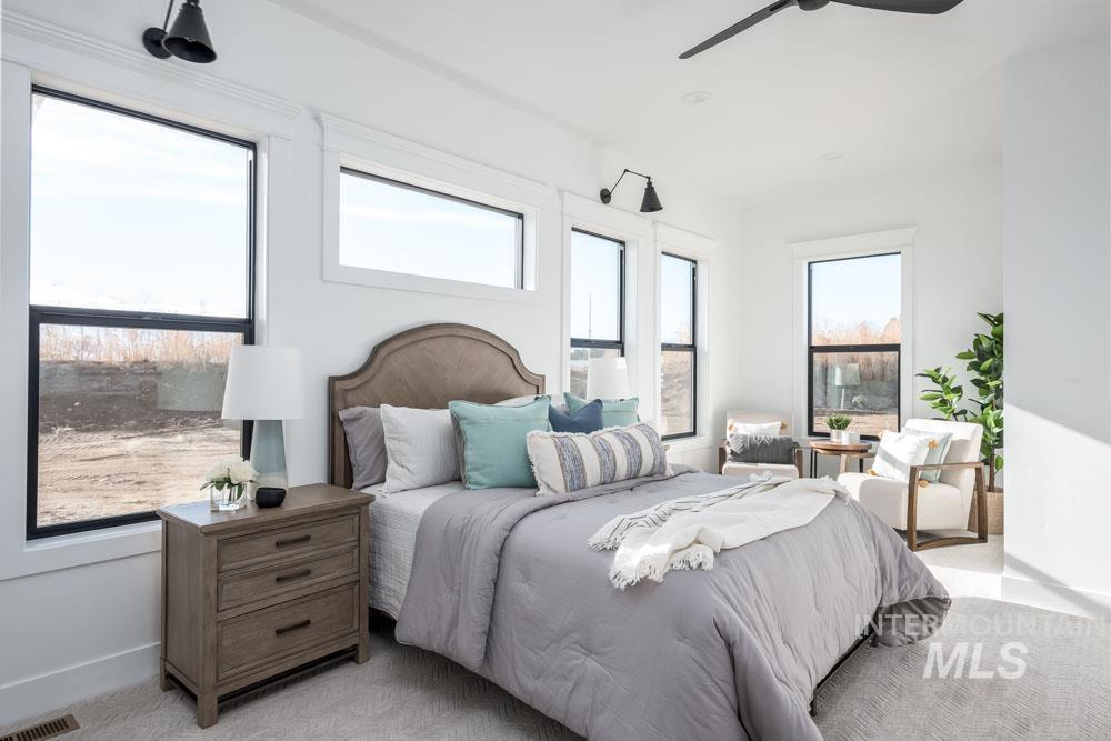 Bedroom with a ceiling fan and carpet flooring