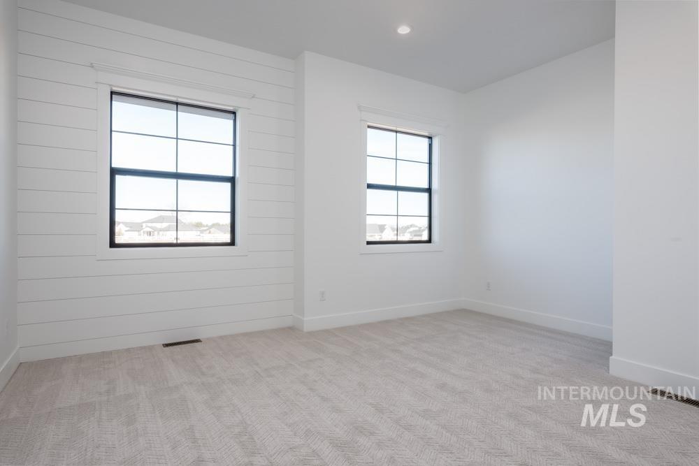 Spare room with light colored carpet and recessed lighting