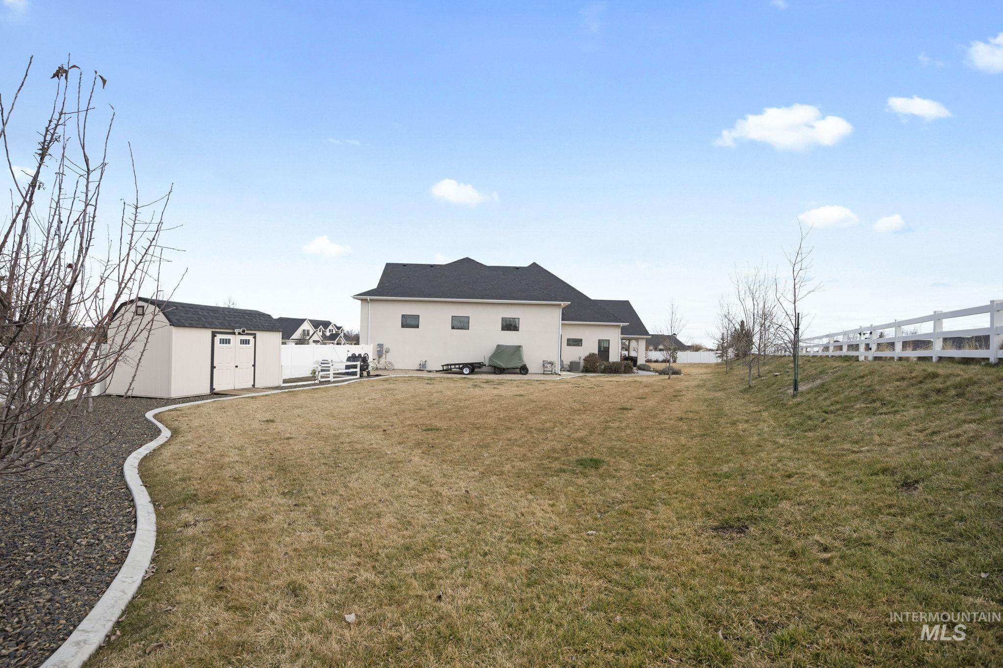 Back of property featuring a storage shed