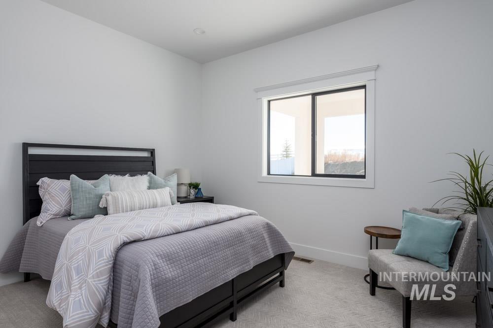 Carpeted bedroom featuring baseboards
