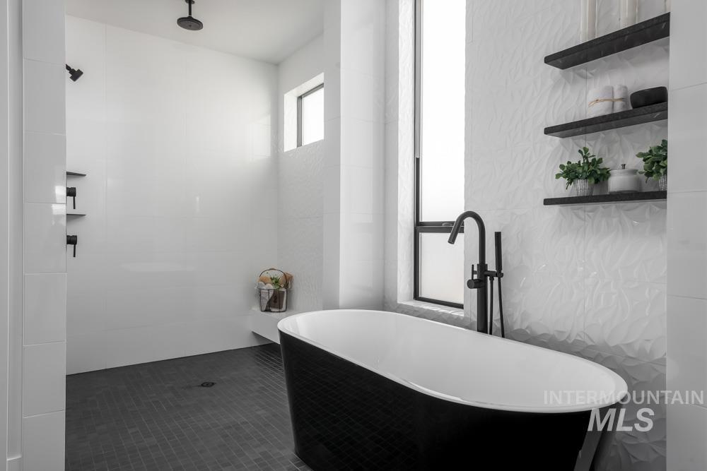Full bath featuring walk in shower and a freestanding bath