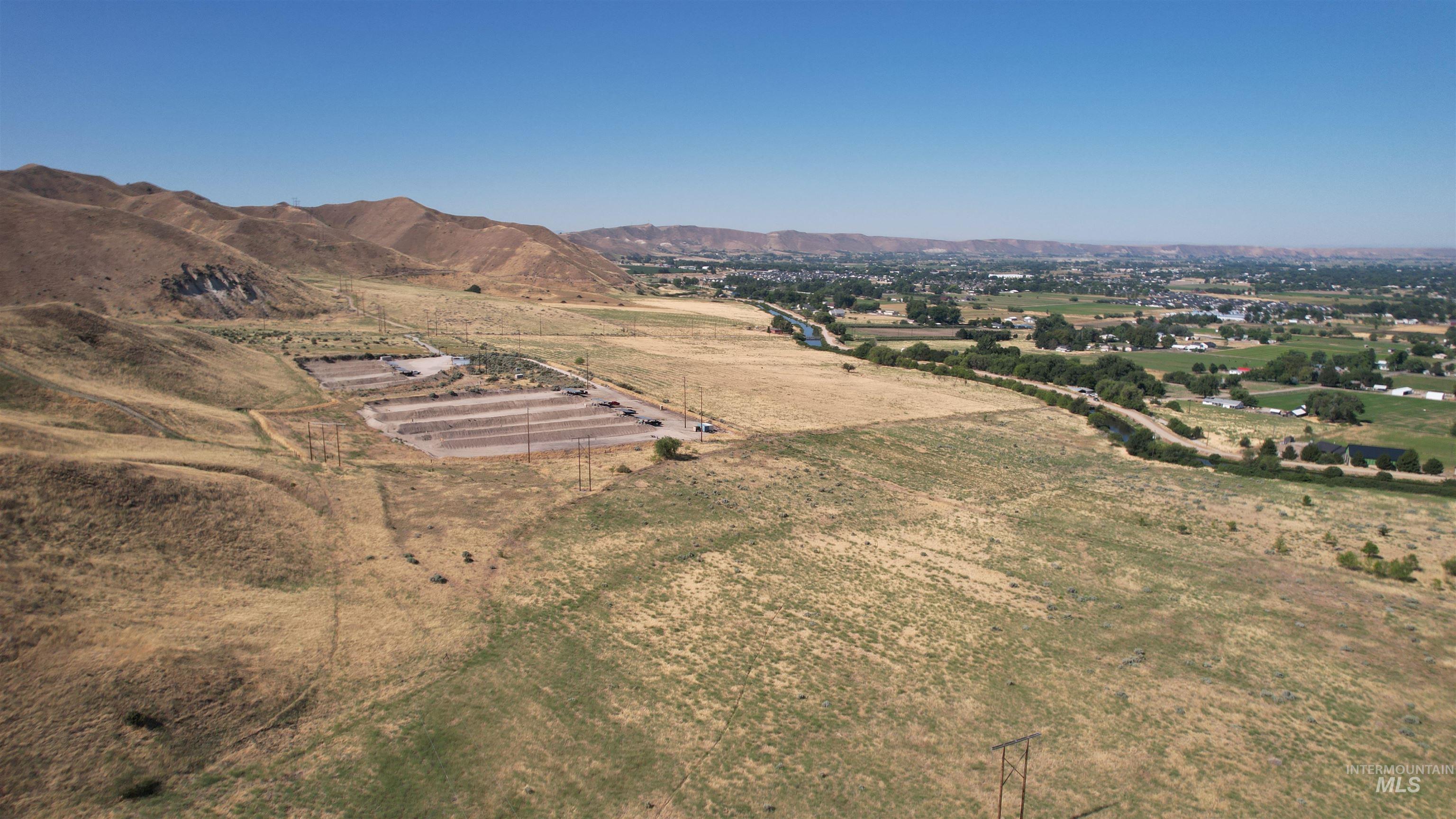 Aerial view of property's location featuring rural landscape and mountains