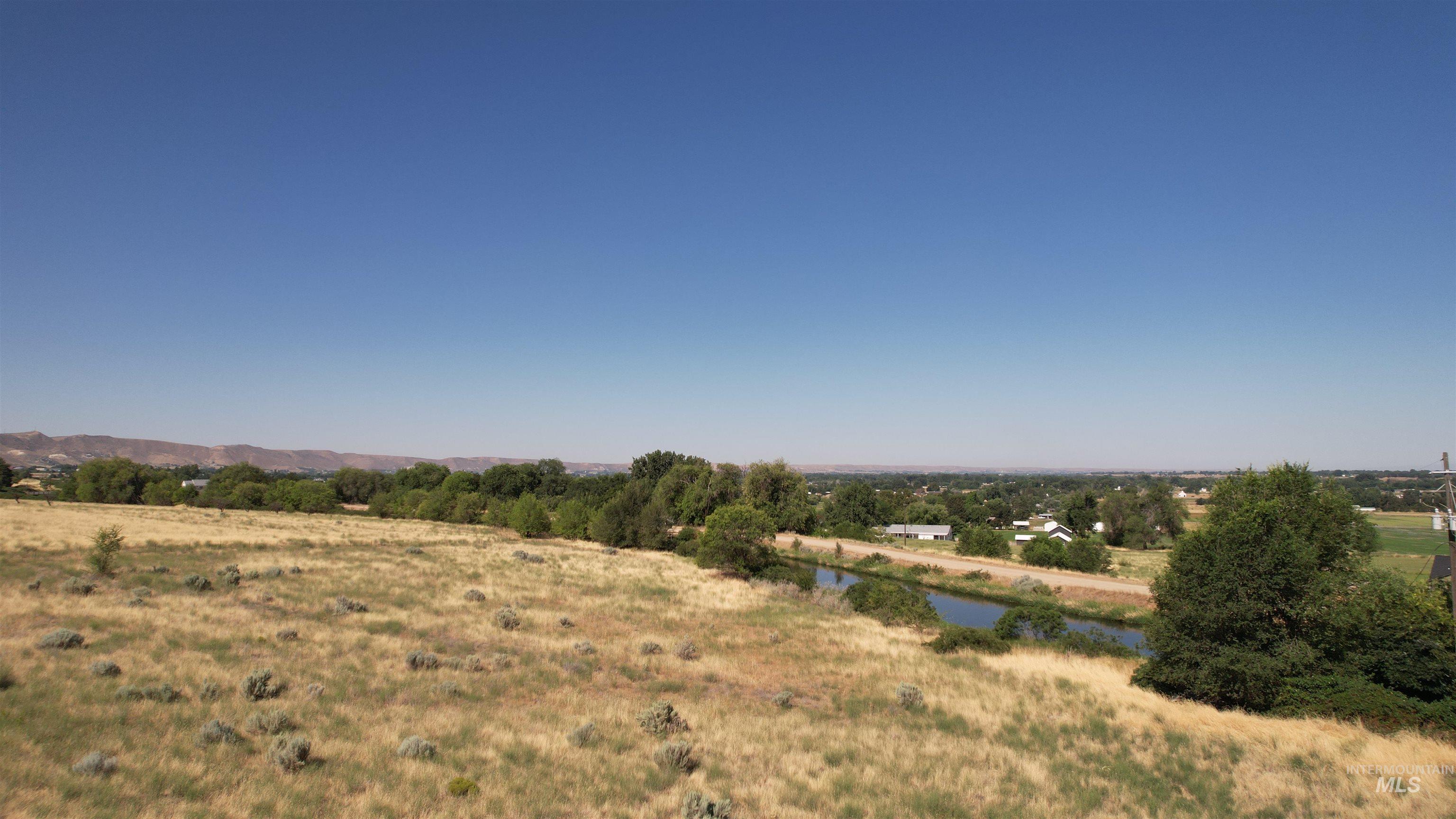 View of undeveloped land featuring rural landscape and a nearby body of water