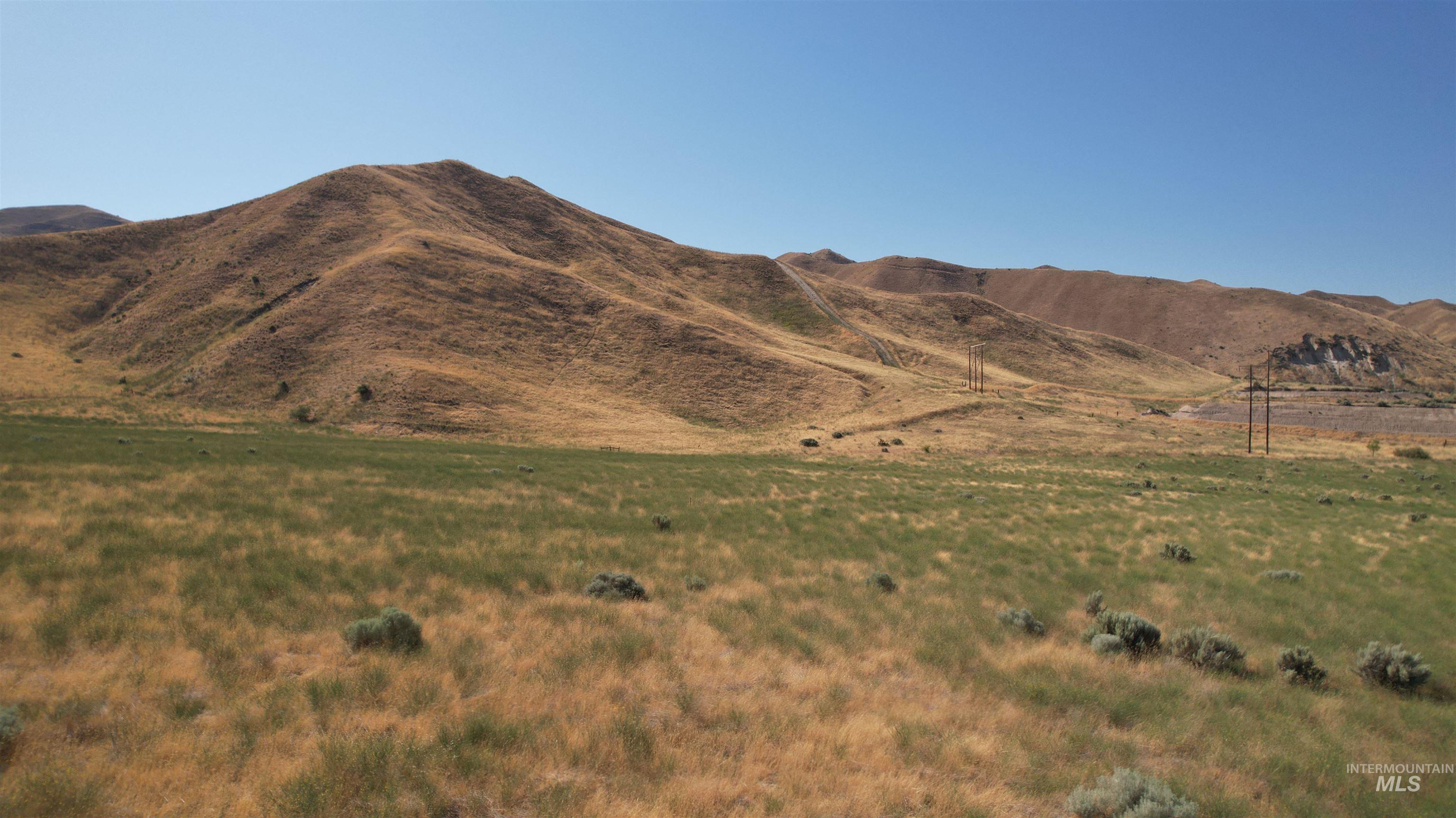 View of mountain backdrop featuring rural landscape