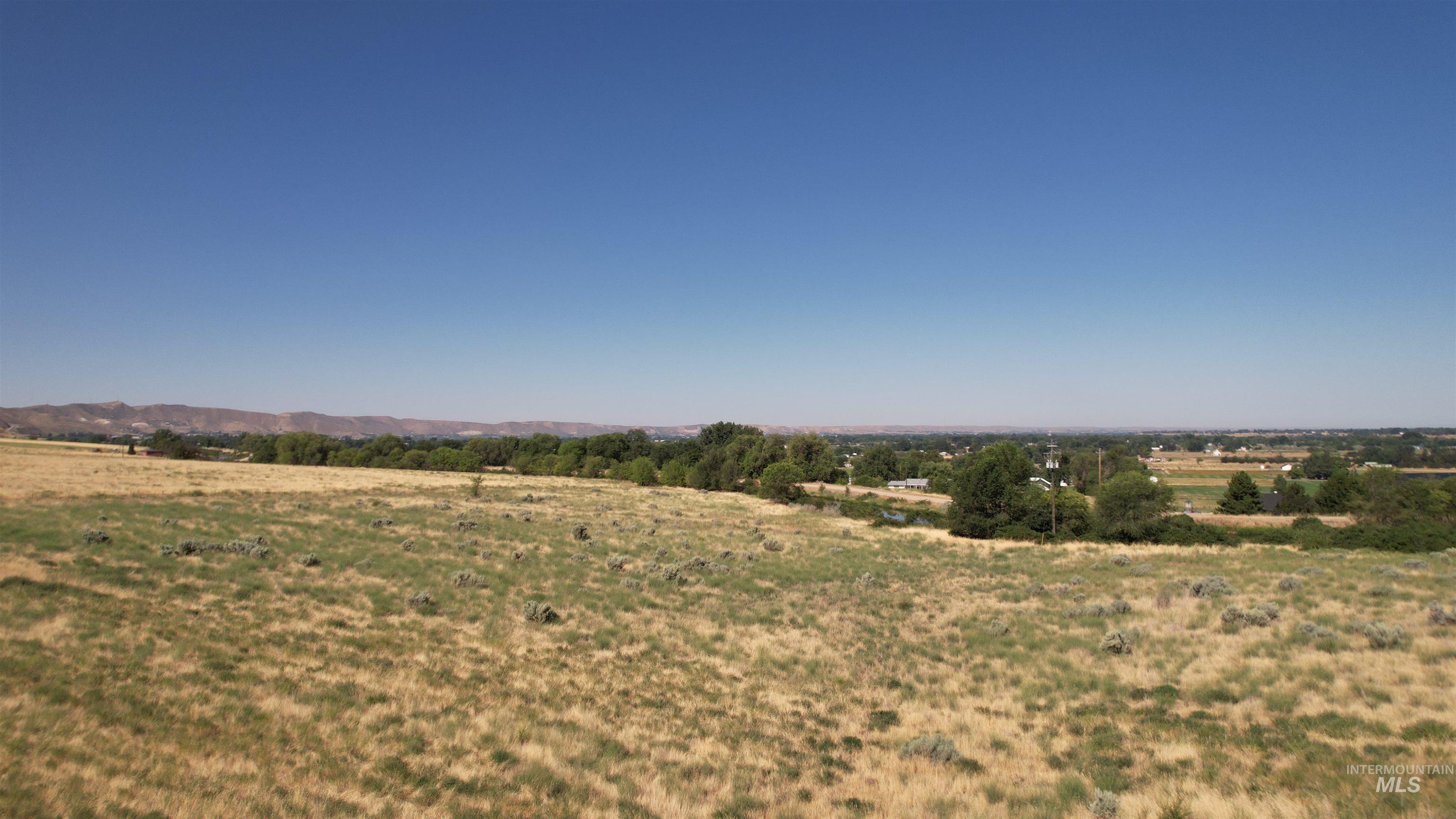 View of undeveloped land featuring rural landscape and mountains