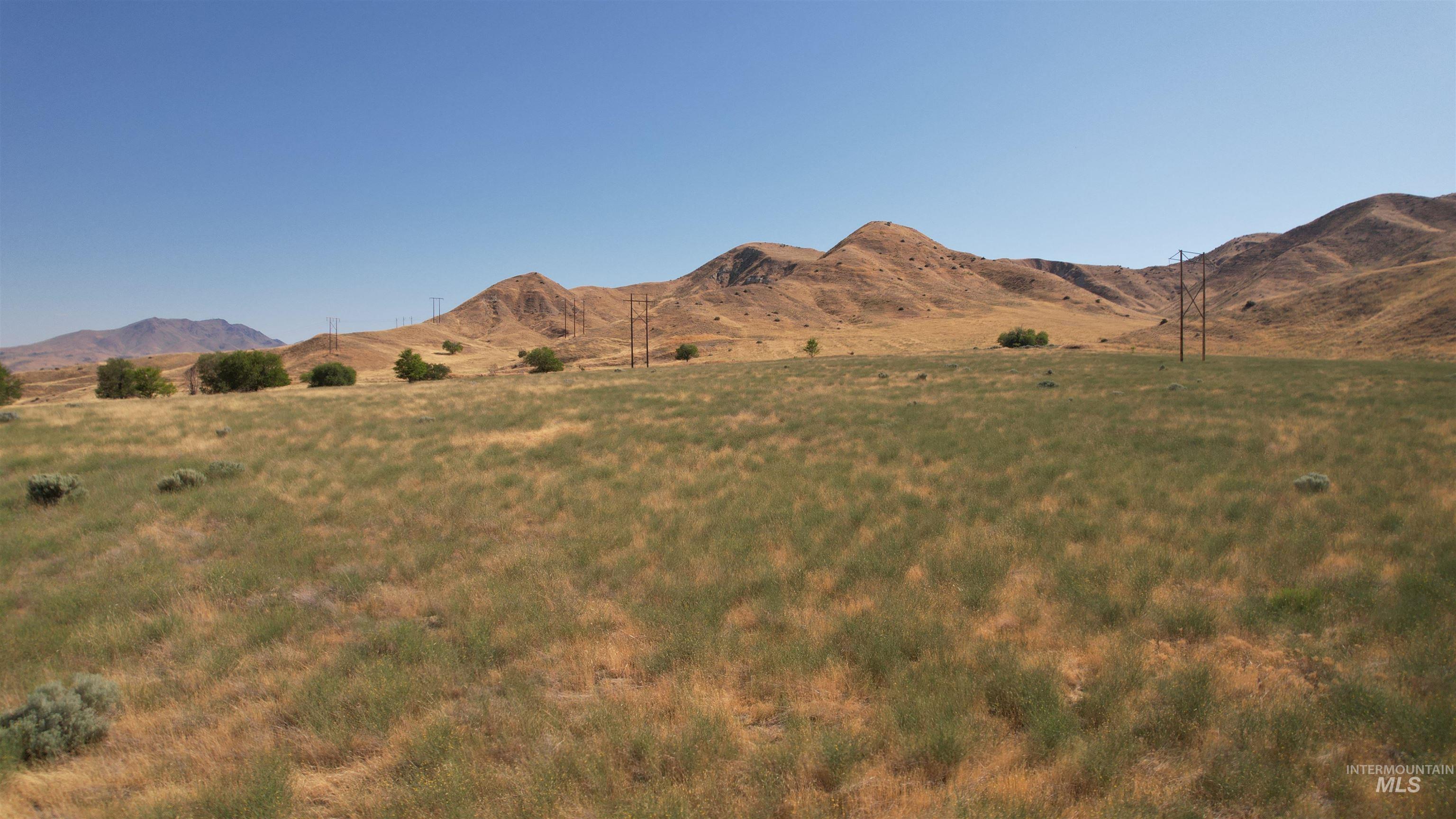 View of mountain backdrop with rural landscape
