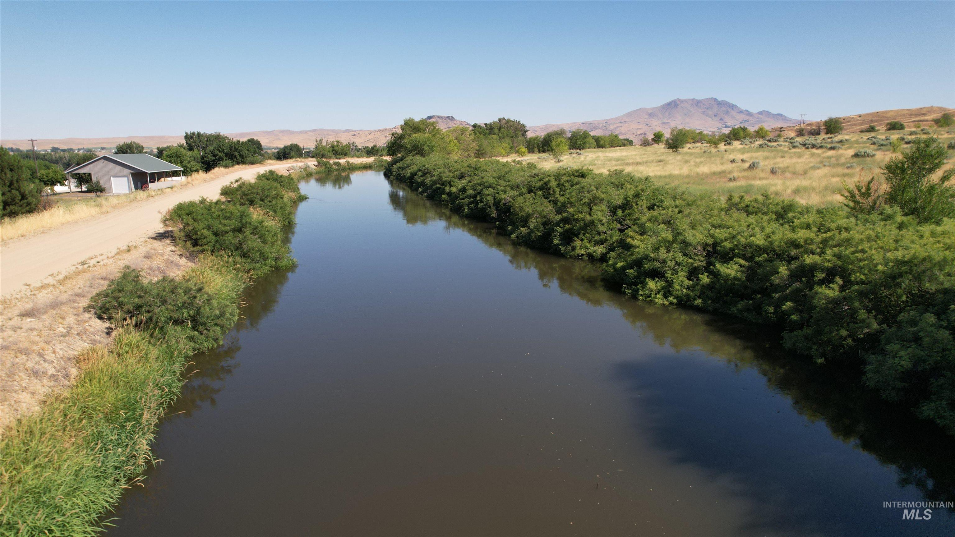 Water view with a mountainous background and rural landscape
